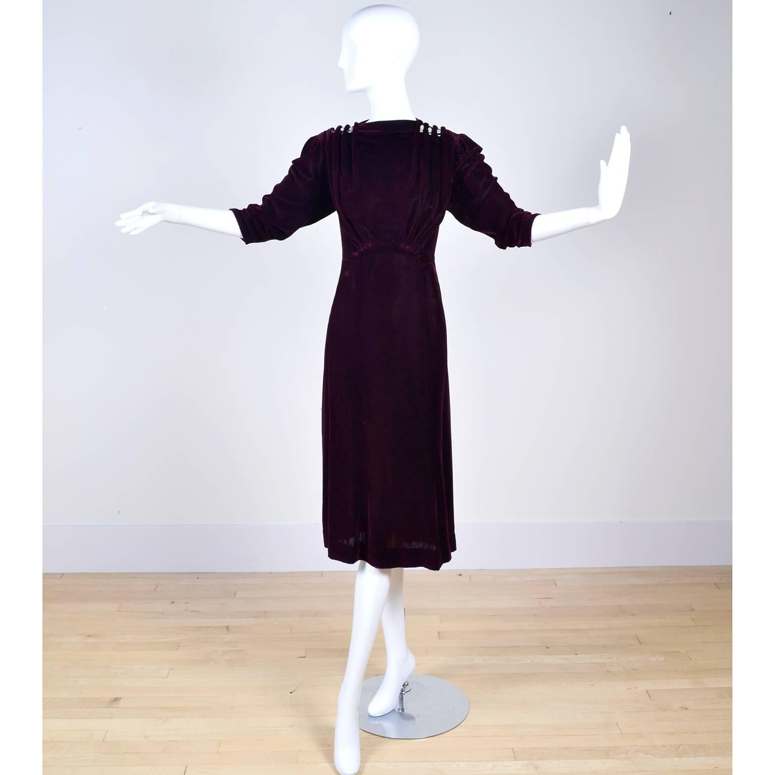 This ultra luxe deep burgundy silk or rayon velvet dress was purchased at Alexander's Women's Apparel in Spokane Washington in the 1930's.  The dress has rhinestone dress clips built into the gathered shoulders, gathered sleeves and a side and back
