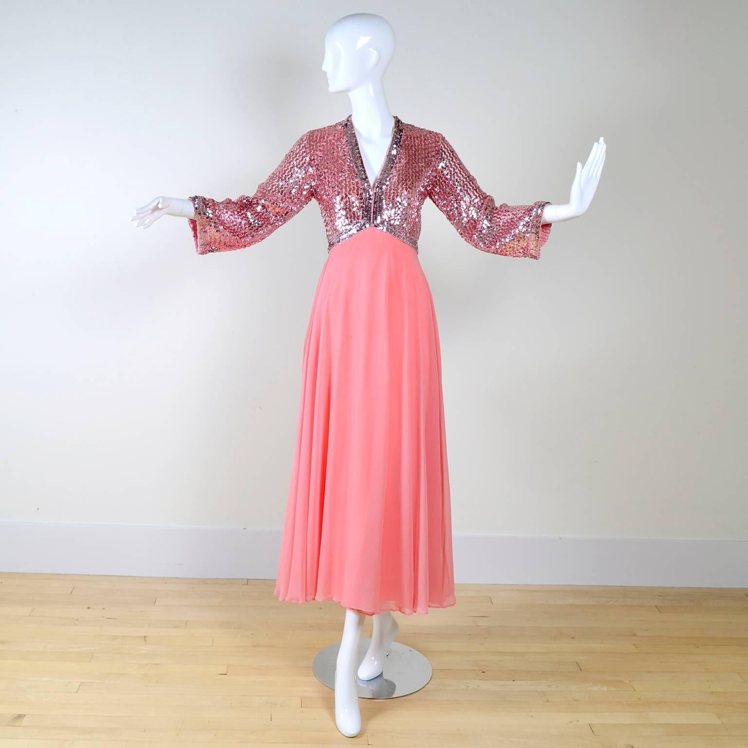 Gorgeous late 1960's or early 1970's pink dress with a lined chiffon skirt and deep V neck. The empire bodice is covered in silvery pink sequins, and is lined. This dress is in very good condition, with just a few loose threads. The arms are 3/4