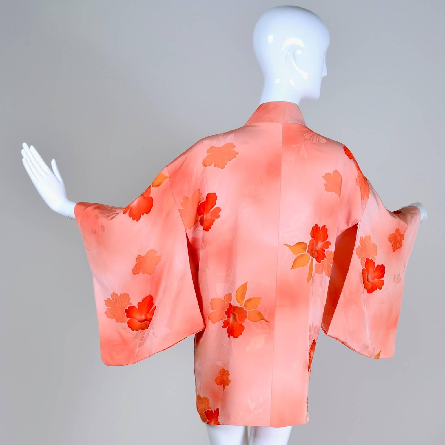 This is an exquisite vintage 1930's or early 1940's silk Haori style kimono in shades of peach with beautiful, bold hibiscus flowers.  This kimono is a one size fits most piece and it has inner ties for closure in the front.  This came from an