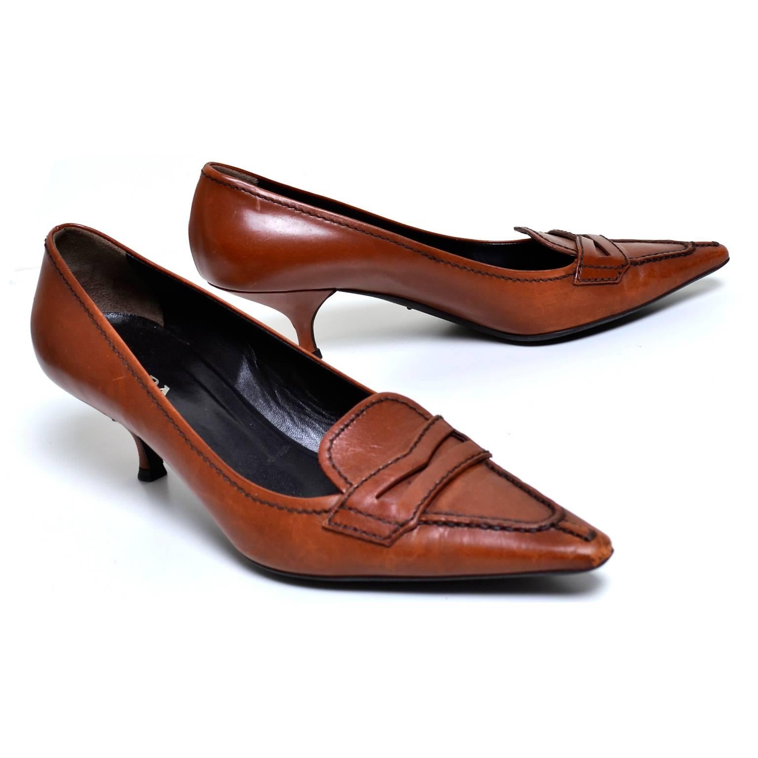 These are great vintage Prada loafers with a stylish pointed toe and perfect kitten heel. These loafers are a cognac brown, with dark brown stitching and a rubber sole. They are marked as a size 37 which is approximately a US women's size 6.5  and