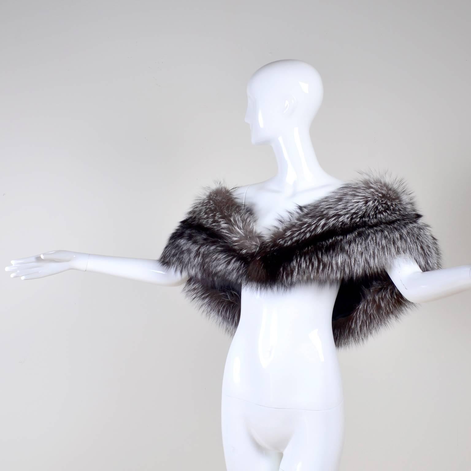 This is an outstanding silver fox fur wrap from Carolina Herrera that was purchased at Saks Fifth Avenue.  This stunningly beautiful stole has a knotted ball front closure and is beautifully lined in silk.  The wrap fits most and measures 26” across