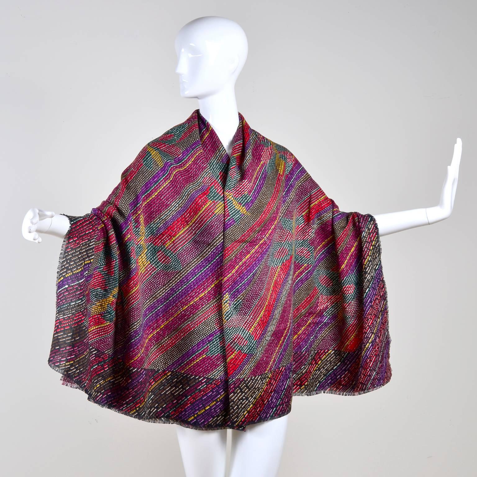 This incredible Bottega Veneta Scarf is absolutely beautiful! This gorgeous scarf was made in Italy and is 70% wool and 30% silk. The abstract pattern is multi colored with beautiful butterflies! This scarf can be worn as a wrap because it is so
