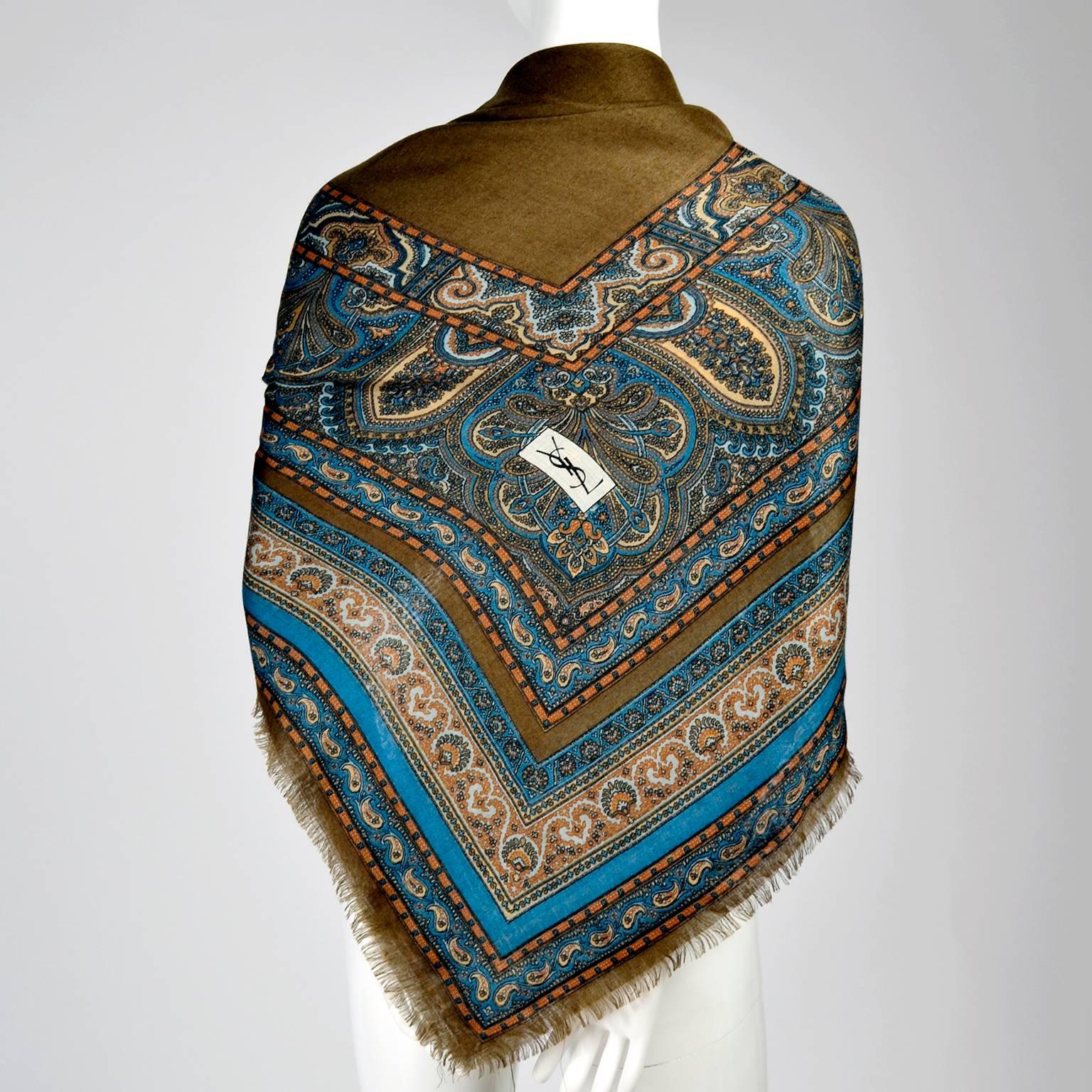 This is an outstanding Yves Saint Laurent ultra fine wool scarf in rich tones of brown, blue and copper measuring 52