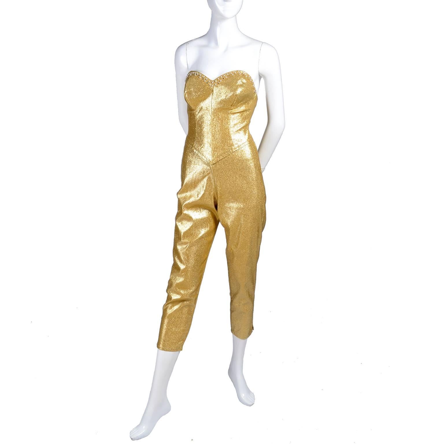 This is a spectacular rare 1950's vintage strapless jumpsuit from Tobi California in gold with a heart shaped bust line trimmed in pearls and rhinestones. This stretch jumpsuit has built in bra cups and zips up the back.  We estimate this stunning