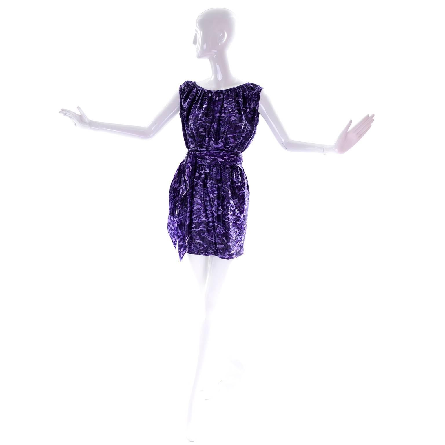 This is a fabulous Marc Jacobs  purple and black metallic abstract animal print mini dress. This sleeveless dress has a fabric sash that ties over an elastic waist. This dress is fully lined and we estimate it to fit a modern day size 4/6.  This fun