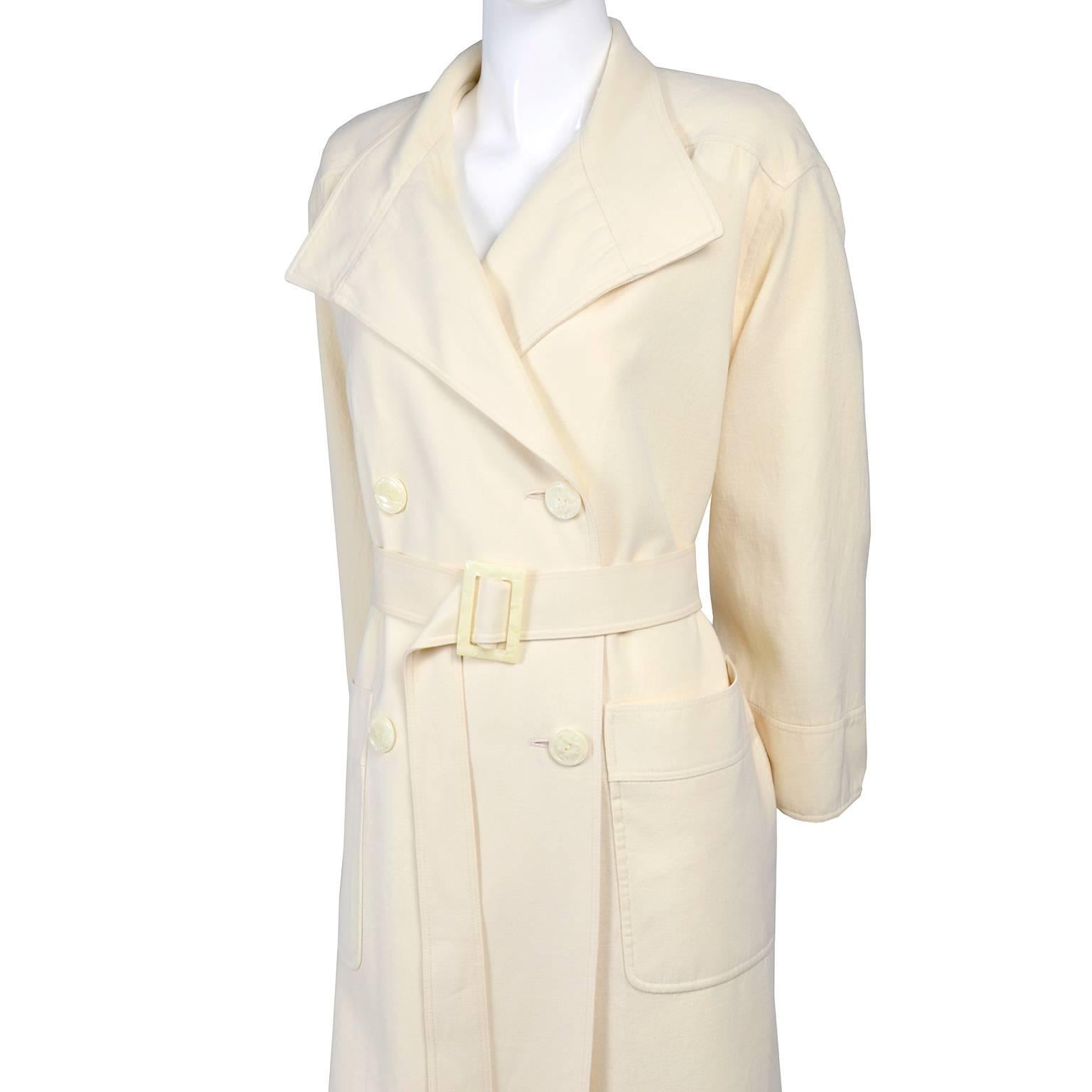 This vintage Valentino coat is a perfect winter addition to your wardrobe!  A Valentino Boutique long cream wool belted trench coat. 
with six mother of pearl buttons, flared sleeves, two hip patch pockets and the matching belt with MOP buckle. This