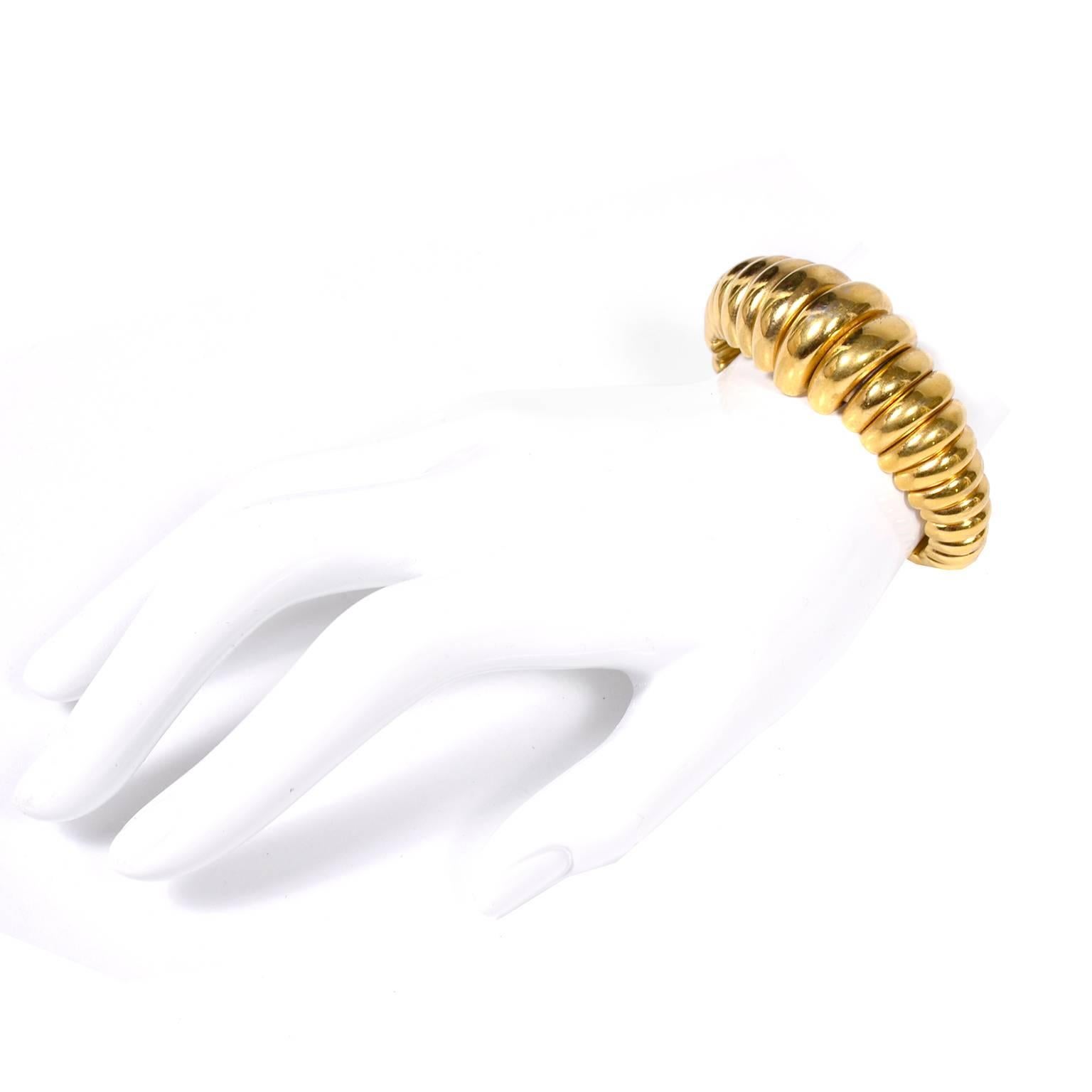 We love this YSL vintage gilded gold metal cuff bracelet. YSL jewelry has become very collectible and it's getting harder to find! This gold tone ridged Yves Saint Laurent bracelet is marked YSL -  Made in France - E8. The cuff measures 1