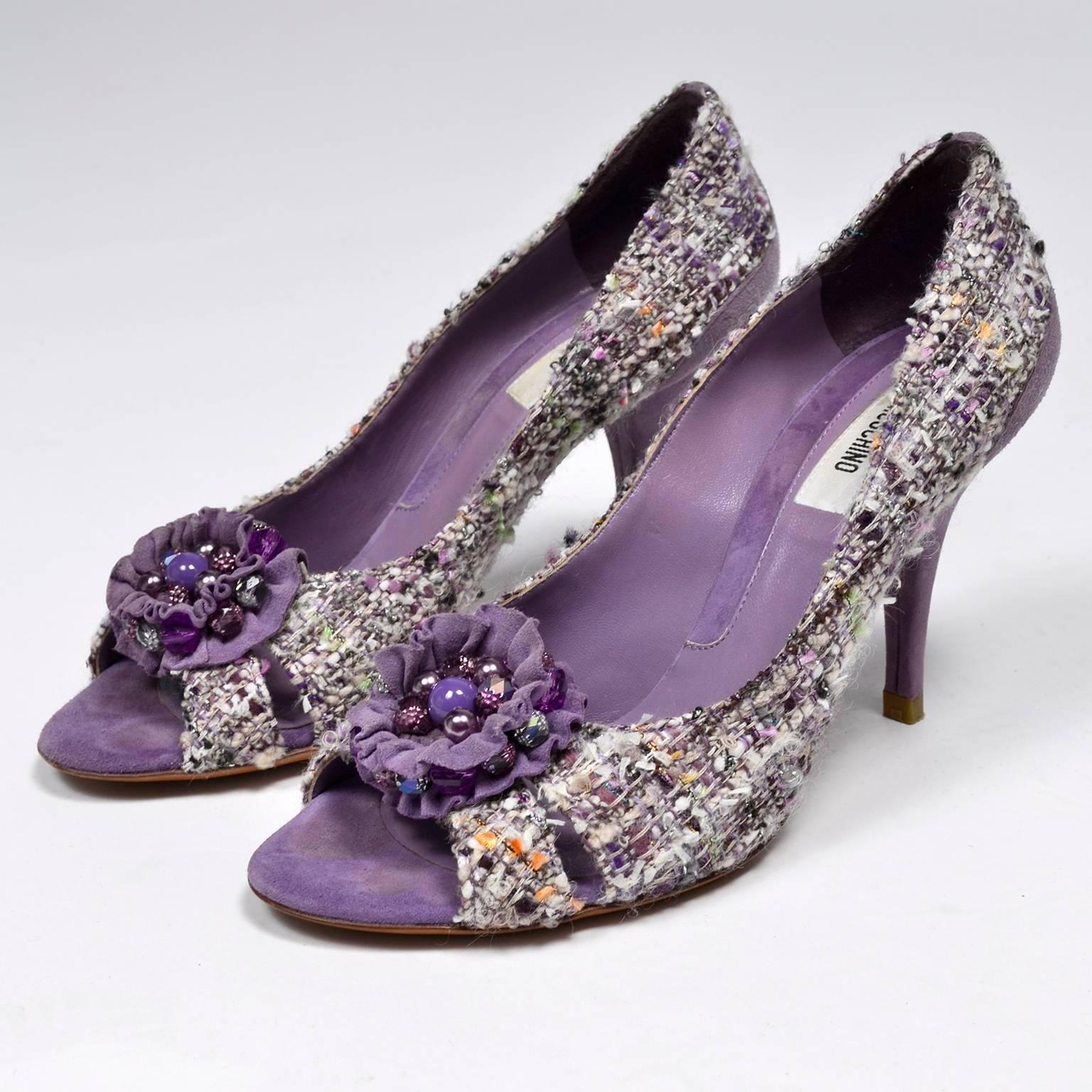 This is a great pair of vintage Moschino purple tweed open toe shoes with beaded suede bows or rosettes and 3.5” purple suede heels. The shoes are labeled a size 37 and 1/4” wide at the widest part of the outside of the sole. 