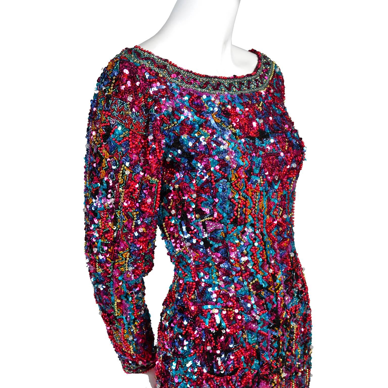 This is a stunning 1980's vintage Oleg Cassini black tie dress that is covered in colorful beads and sequins.  This beautiful red, blue, green and pink dress is silk with rayon lining and is labeled a size 6.  We estimate it to fit a modern day size