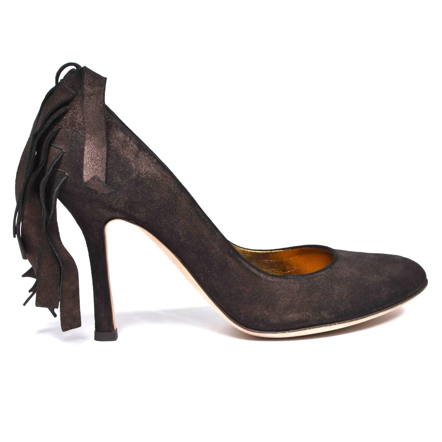 These are fabulous DSquared2 brown suede heels with a slight metallic sheen and copper leather lining. These pumps have a rounded toe and suede fringe tassels cascading in layers down the back of the heel. They look to have been worn once, and show