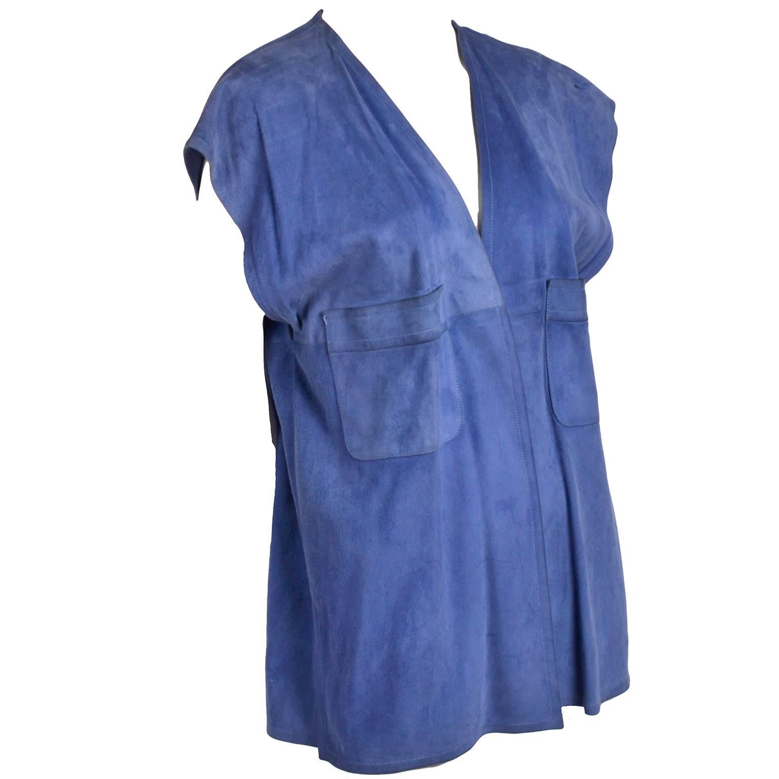 This is a great 1970's vintage Gucci blue suede open front vest with two breast pockets. This sleeveless top has no closures, and was made in Italy. It is in very good condition, with natural darkening to the leather along some edges. It has a slit