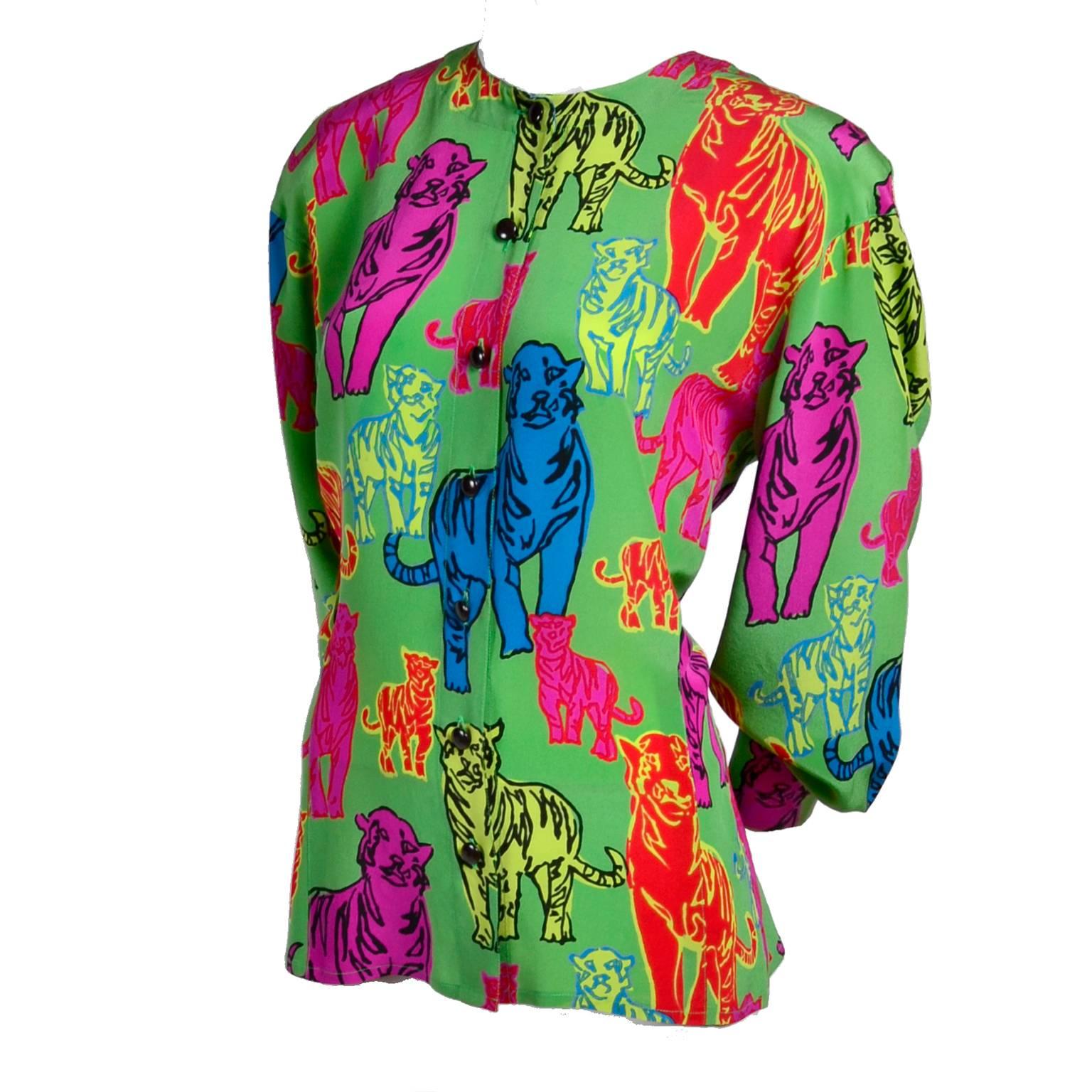 This is a stunning late 1980's or early 1990s Margaretha Ley for Escada green silk blouse in a bright colorful Andy Warhol-esque tiger print in yellow, pink, red, blue and green. This unique pop art blouse is collarless and buttons down the front.