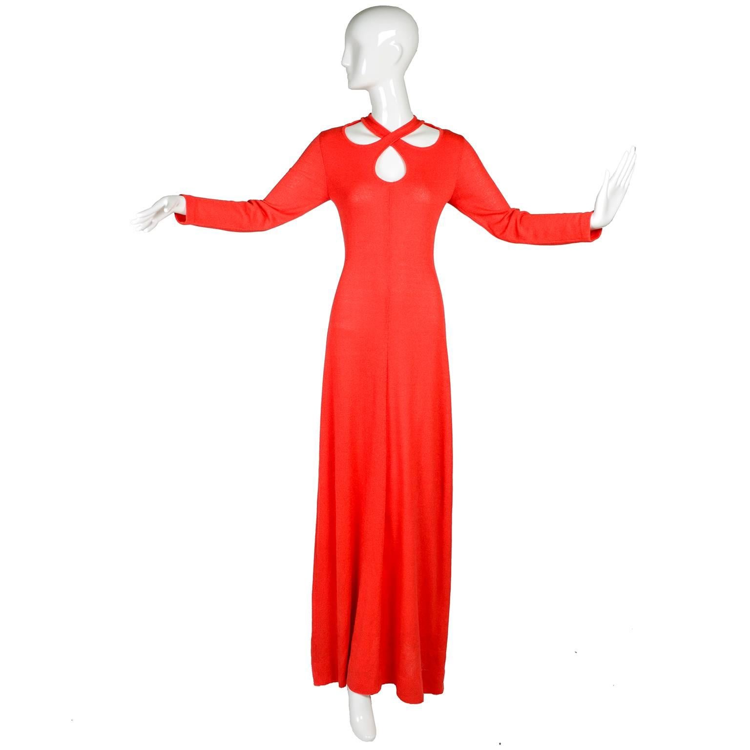 This is a wonderful 1970's Arbe Imports orange red stretch knit maxi dress with a criss crossing bodice leaving large keyhole cutouts. This long sleeve dress zips up the back. Made in Italy. Marked as a size 12, and measures like a modern US size