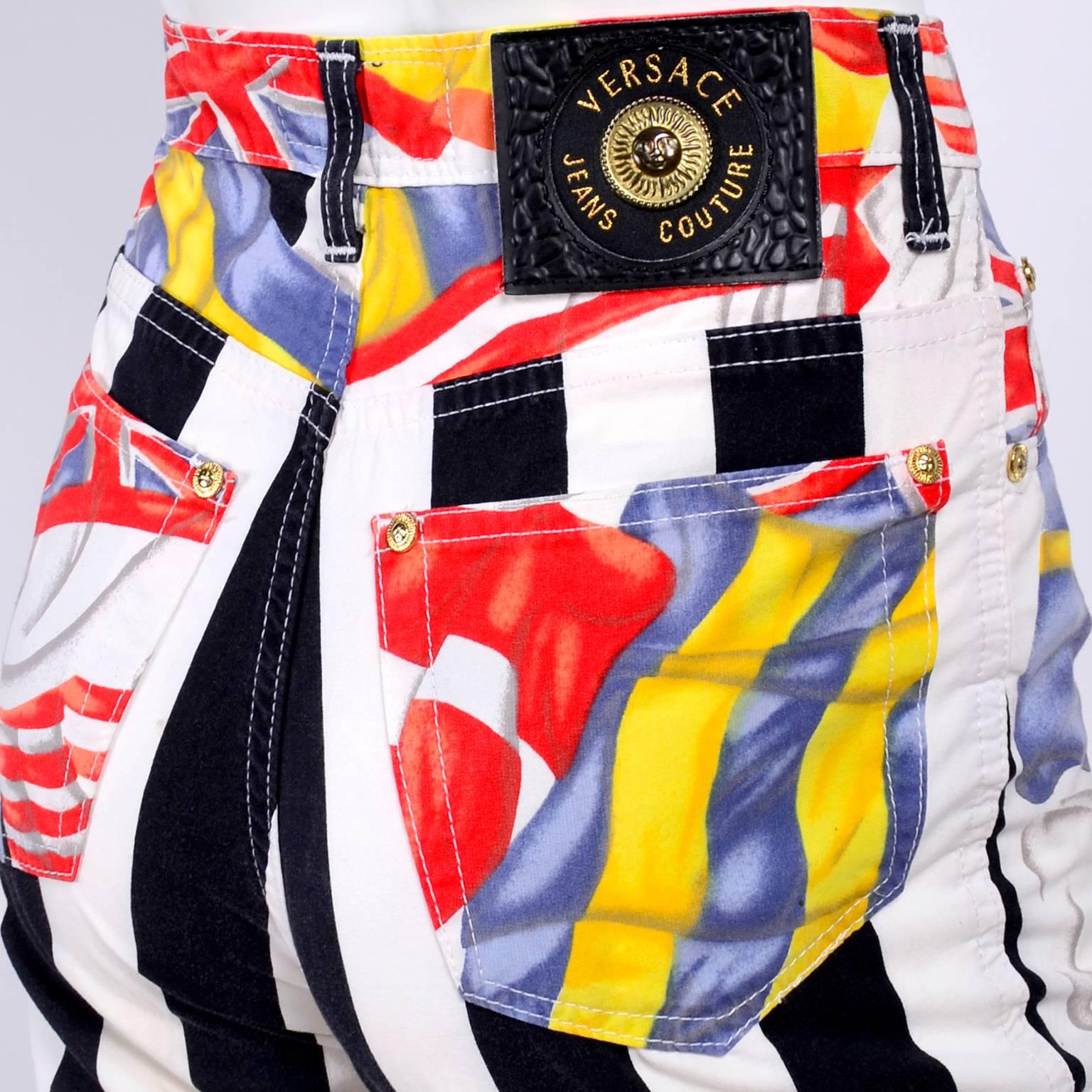 These are very rare Gianni Versace Jeans Couture flag pants from the 1990's. These novelty print jeans have black and white stripes on the back of the legs and flags. We love Versace jeans and these are some of our favorites.  These jeans feature