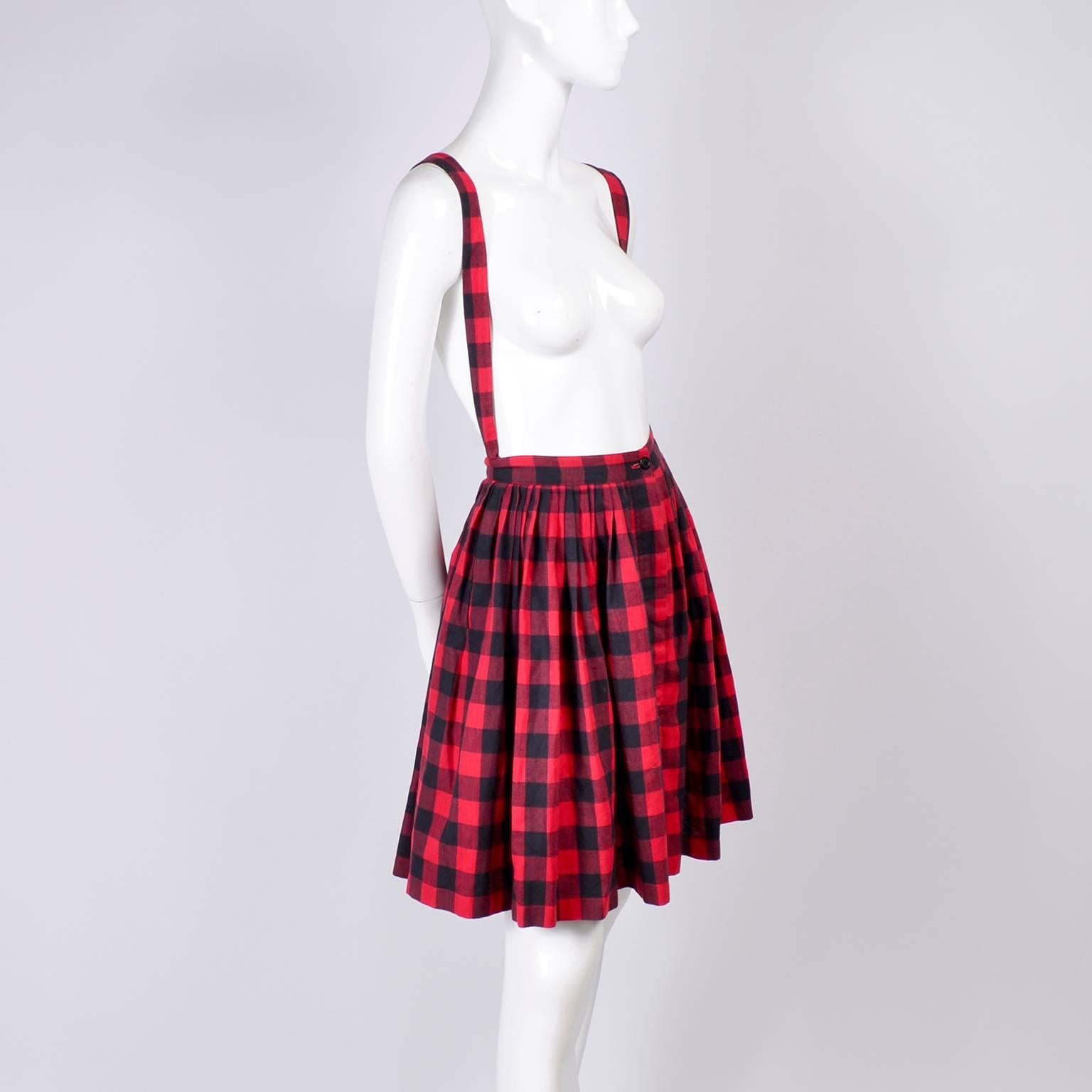 Norma Kamali is one of our favorites so we really love this vintage 1980s red and black cotton plaid skirt with removable suspenders. You can wear this with a fun blouse or a simple tee shirt.  The skirt has side slit pockets and the suspenders have