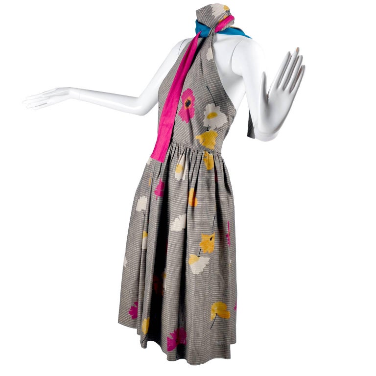This is a beautiful vintage dress from Albert Nipon in a gorgeous linen cotton blend print with micro herringbone stripes and bold pink, yellow and white big flowers.  One of the halter straps are lined in the same pink as the pink flower and the