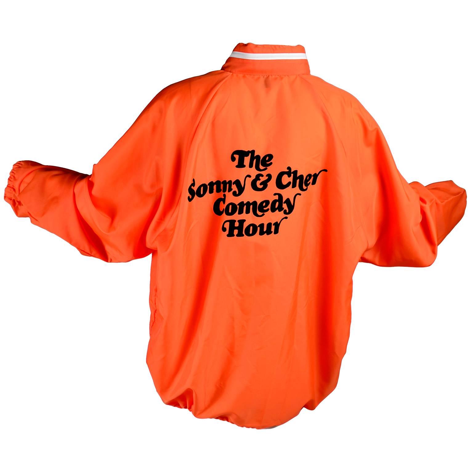 This orange nylon jacket is an original crew jacket from the Sonny & Cher Comedy Hour television show in the 1970's.  This Sonny and Cher Comedy Hour jacket is from 1971 and came from a collector who owned many Cher related items, including several