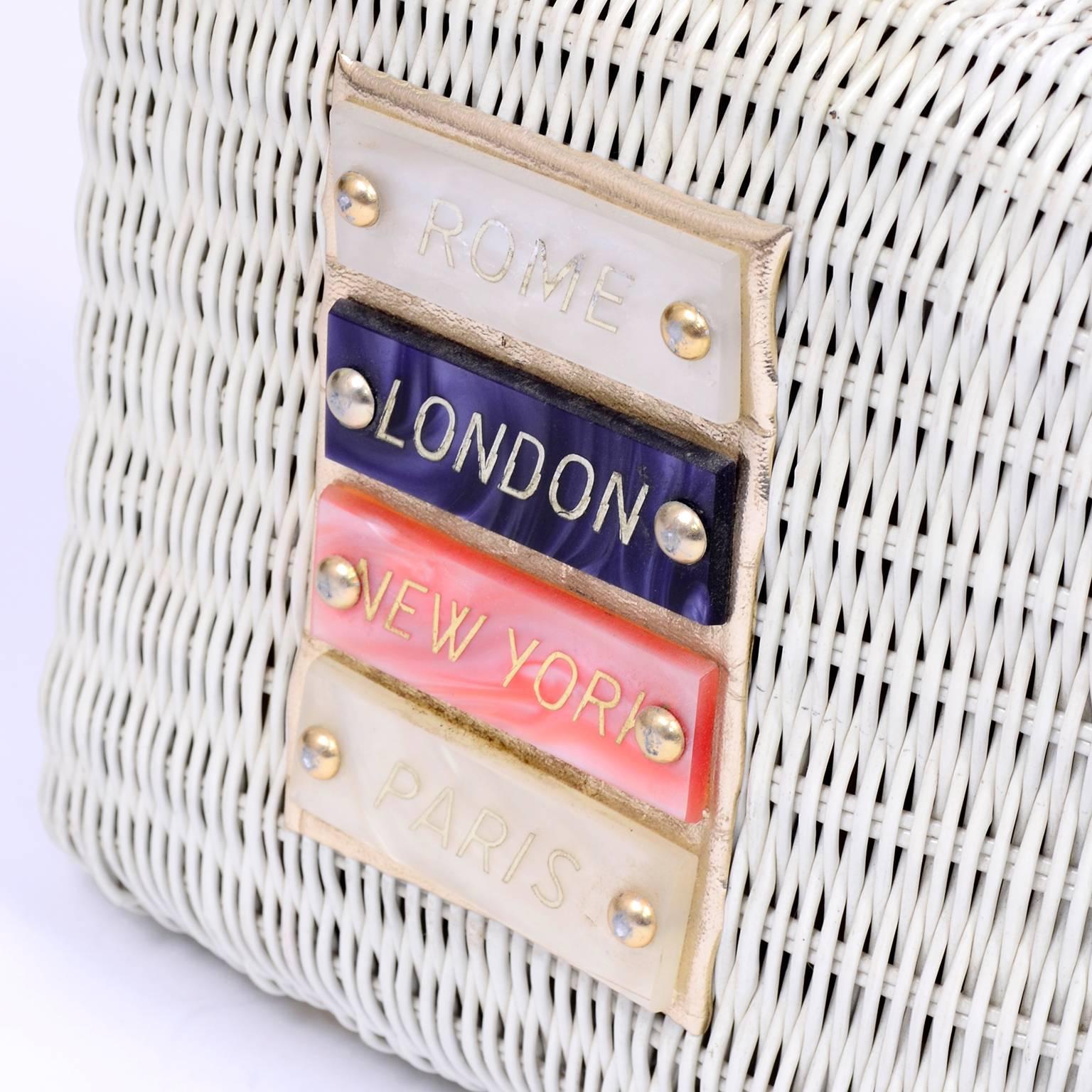 This is a rare mid century vintage ivory wicker handbag with famous city names on the front on lucite plaques including; Rome, London, New York and Paris.  This unique novelty handbag was hand made by Du-Val in Hong Kong in the 1960's. The inside is