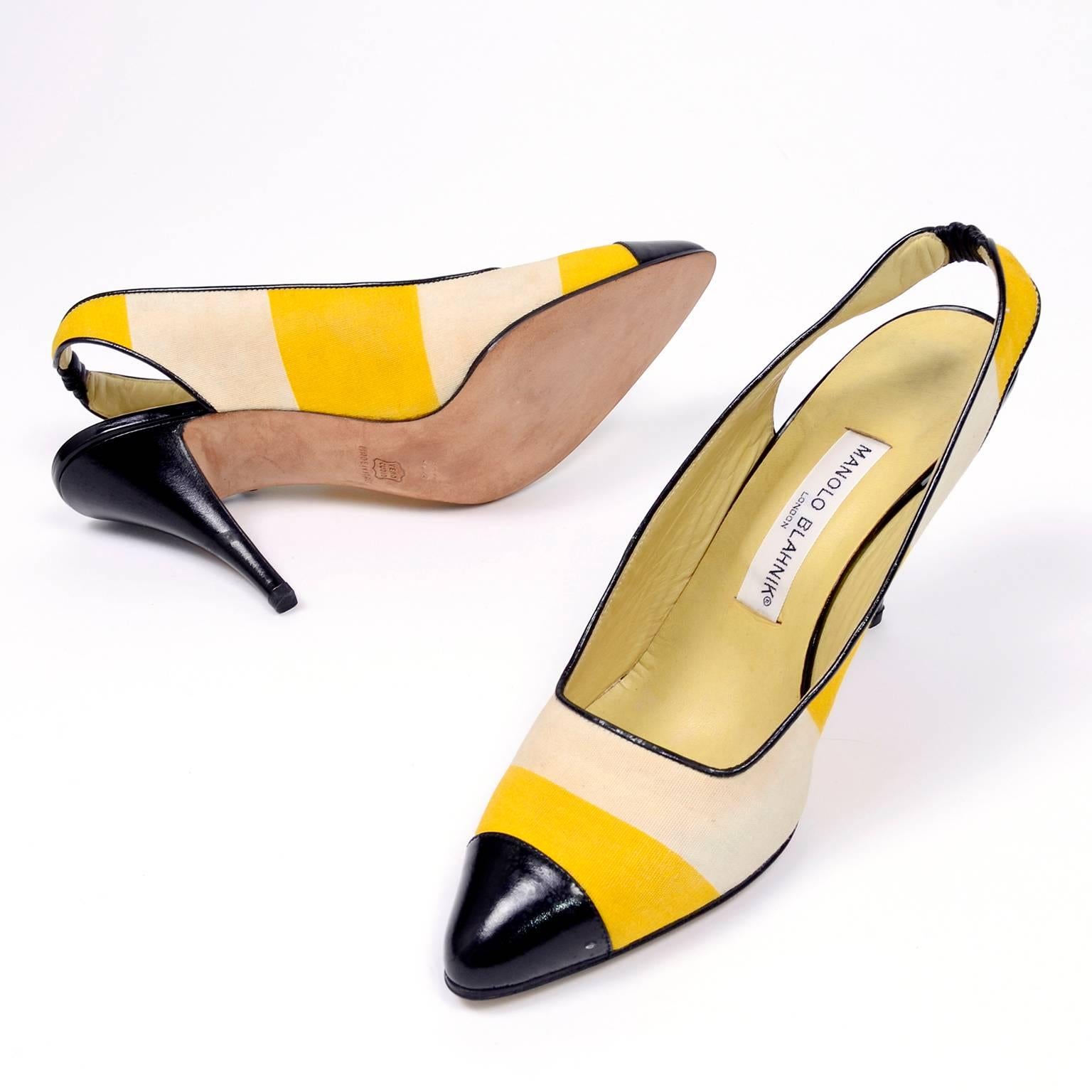 These are a pair of rare 1980's Manolo Blahnik slingback shoes with yellow and cream fabric with black patent leather heels,  toes and trim.  These shoes have 4