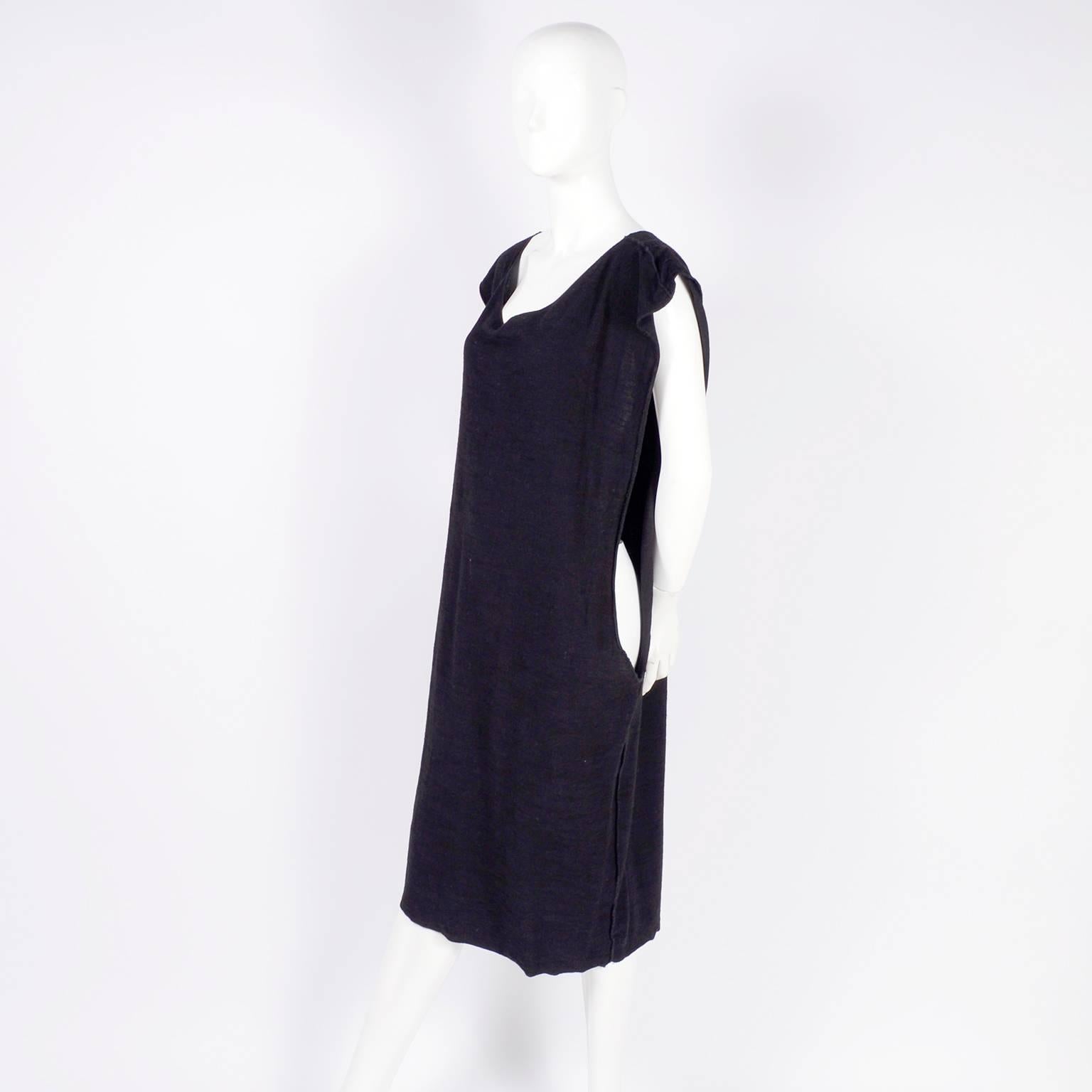 This avant garde 1980's black cotton outfit was designed by Michele Lamy in the late 1980s.  The ensemble includes a dress with long side slits and a loose fitting jacket.  The oversized dress has reverse seams and slips overhead.  Michele Lamy