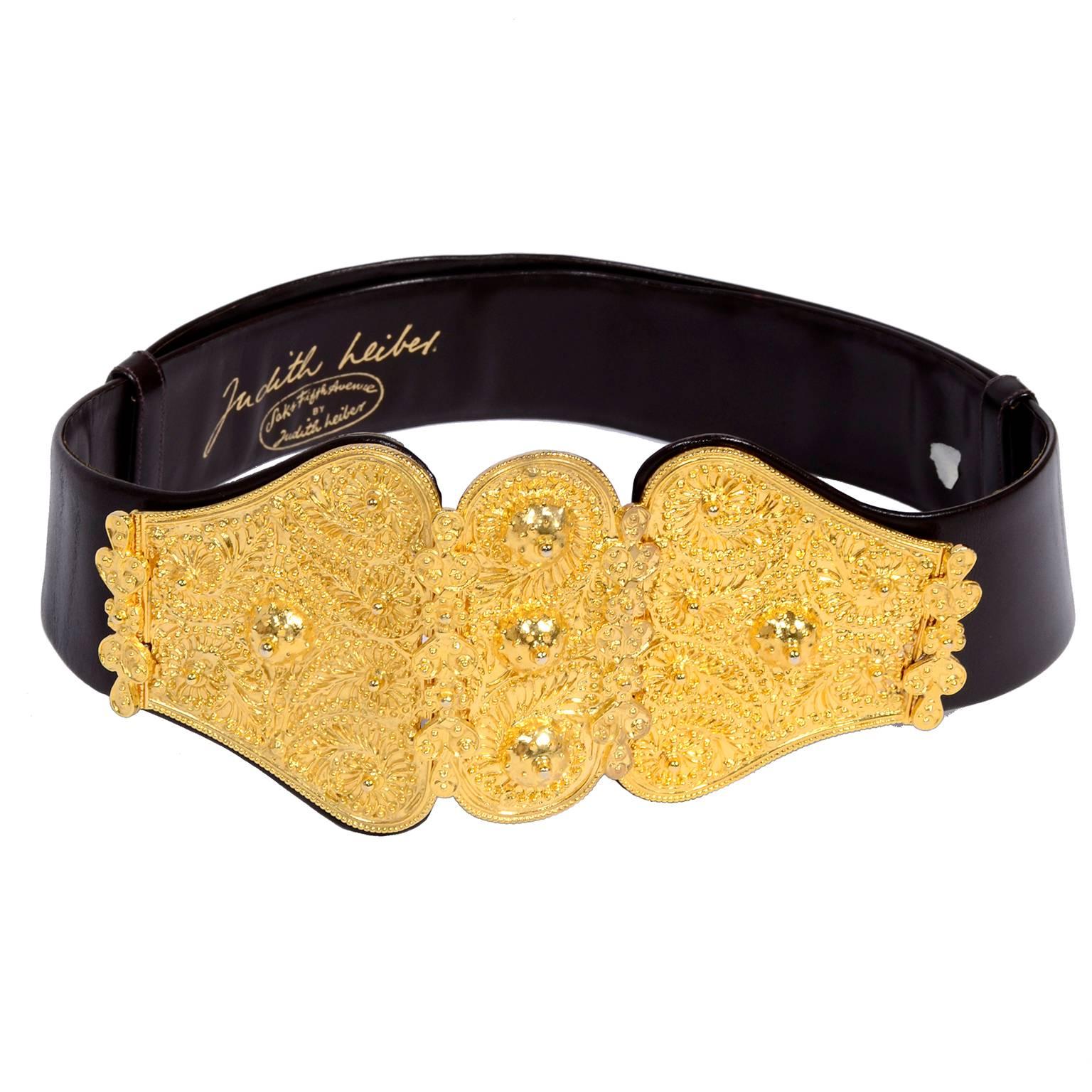 This is a wonderful vintage Judith Leiber leather belt with a gold metal buckle. The buckle has three sections, two attached by a hinge and the third hooks to close. It has an ornate design and beautiful texture. We love the dramatic gold buckle and