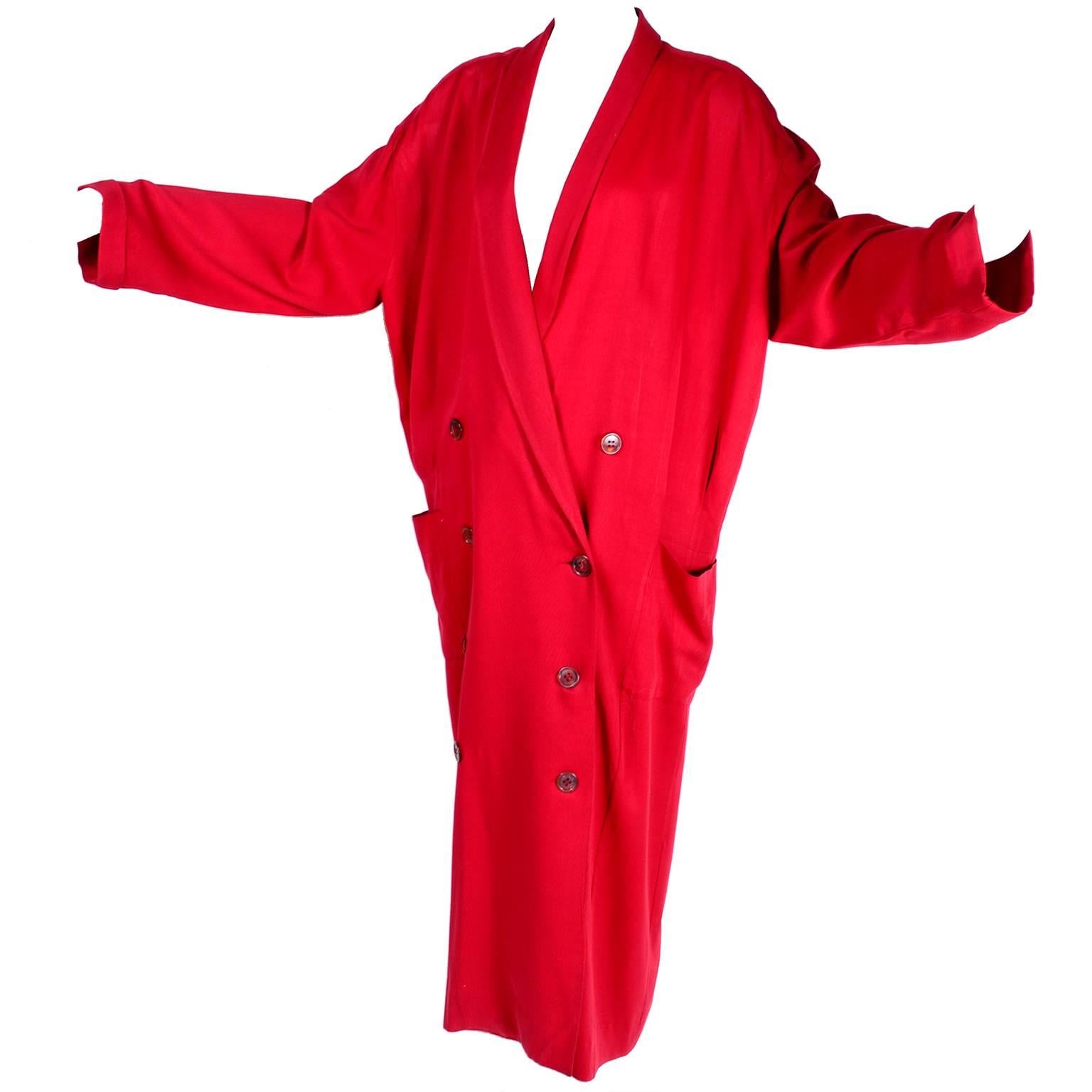 This is a stunning vintage oversized rich red coat from Norma Kamali. This stylish 80s double breasted long coat was designed in the 1980s and has rich red satin lining and front pockets.  The coat was made in the USA and is labeled a vintage size