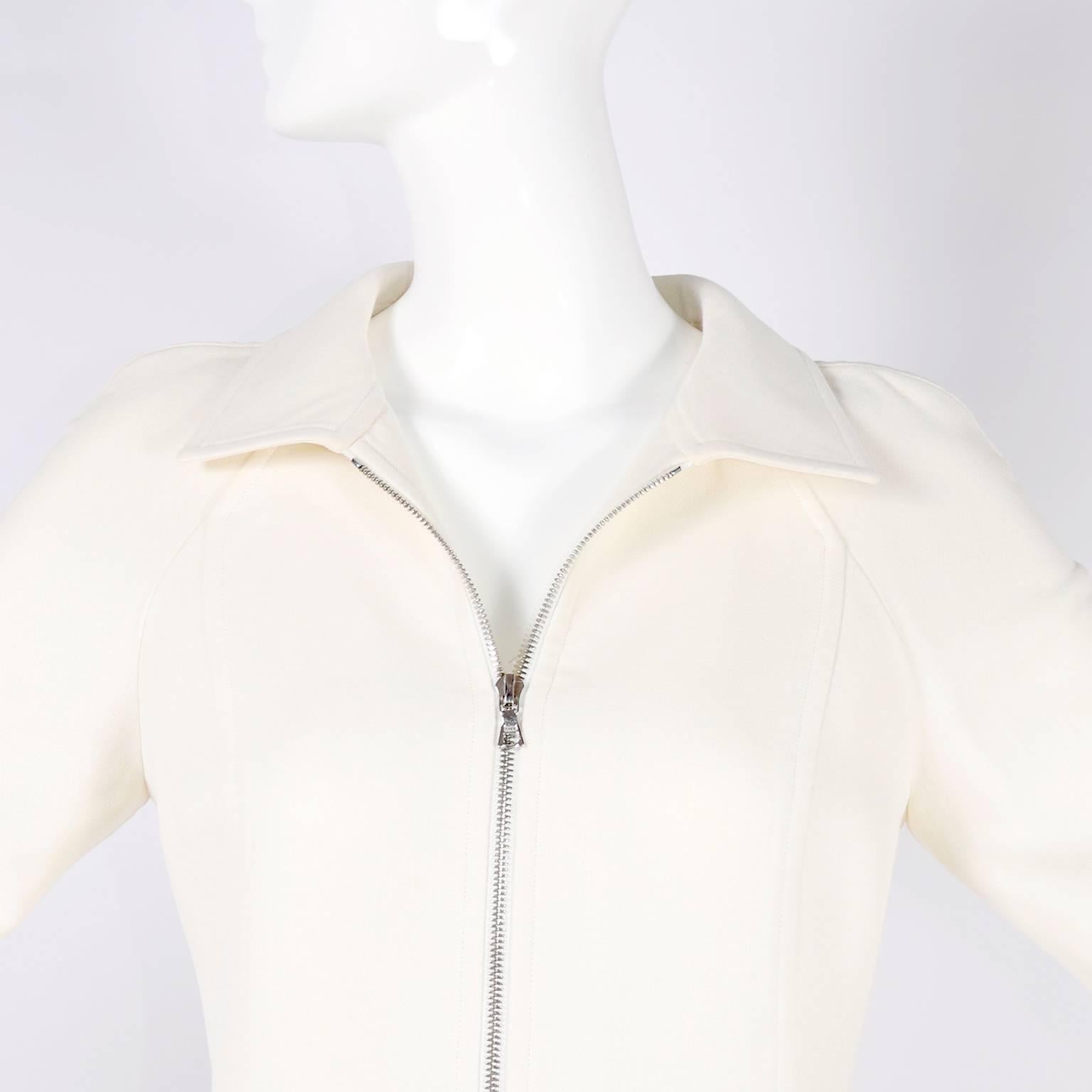 This is a beautiful Courreges coat that zips up the front and has two zip front slit pockets. This coat is such a timeless piece and can be worn with so many different pieces in your wardrobe. This coat is made of a beautiful ivory or winter white