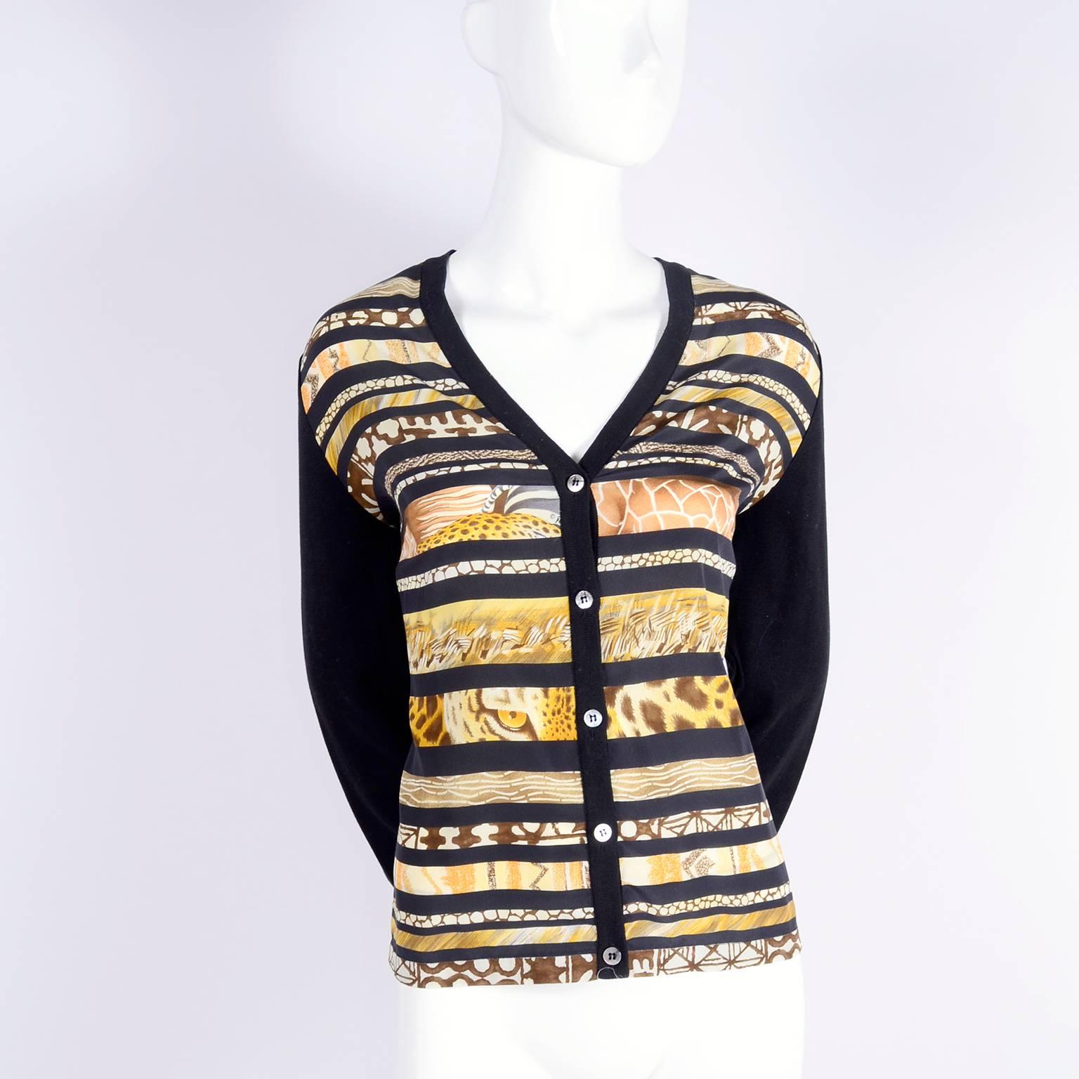 This is a Vintage Salvatore Ferragamo cotton and silk cardigan sweater with a silk scarf print in the front with animal skin prints and animal eyes! We have the coordinating  scarf with the same vertical pattern but with animal prints, hibiscus and