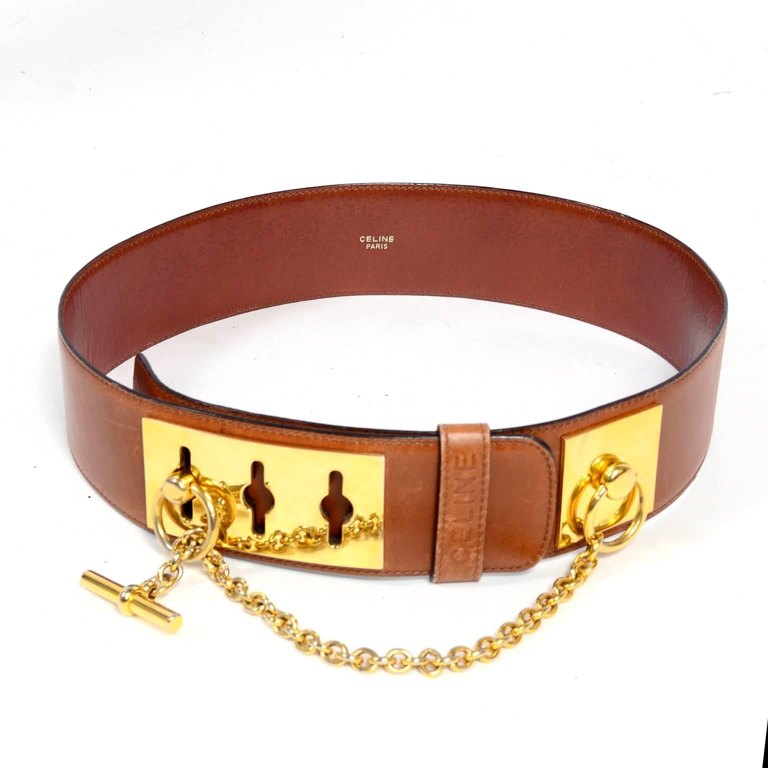 This is a great Celine belt in a pretty medium brown leather with gold tone hardware. This gorgeous waist belt is really incredible in person and both the metal loop bracket and leather are marked Celine. We estimate this belt to fit a size 8/10 and