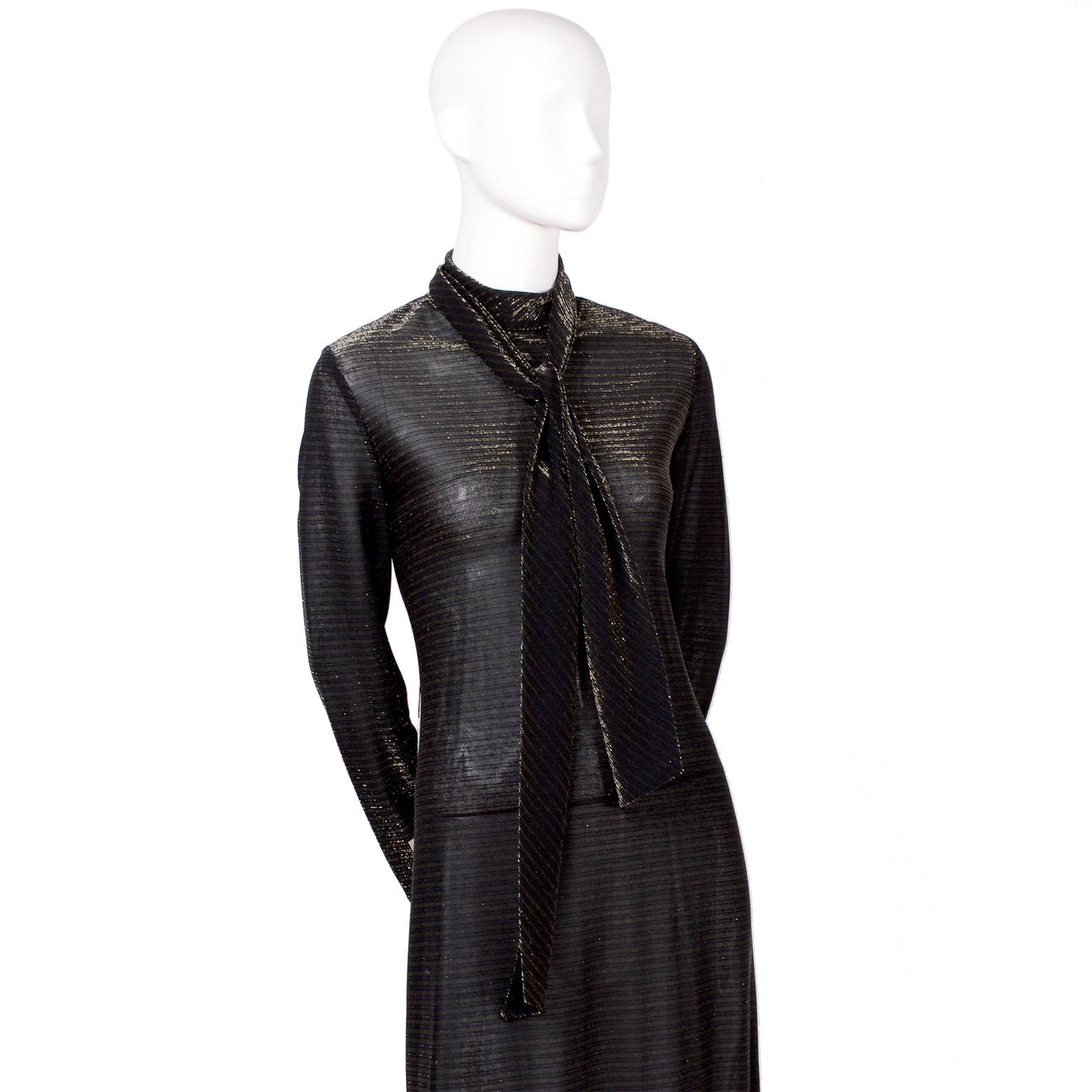This is a great new but vintage 70's sheer black maxi dress with horizontal thin gold stripes. There is a turtleneck tie at the neck that can tie in back, or loop in the back to tie in front. The dress hooks in the back at the neck. Deadstock with