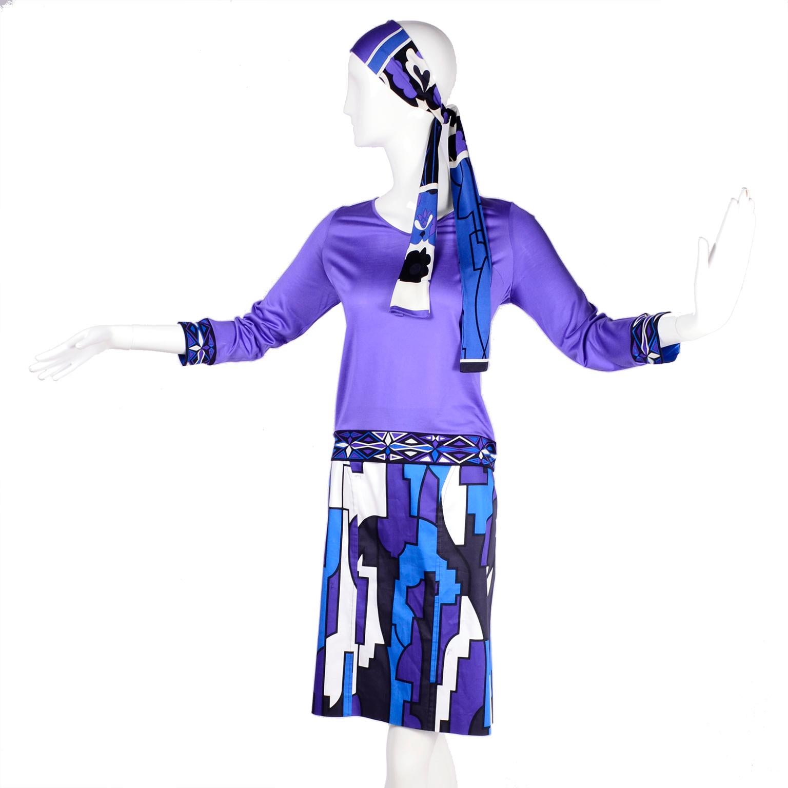 This is a contemporary Emilio Pucci 2 piece outfit with a purple silk jersey top with a patterned hem band and cuffs in purple, blue and white.   The top has a single button at the neck and it comes with a coordinating scarf that can be worn as a