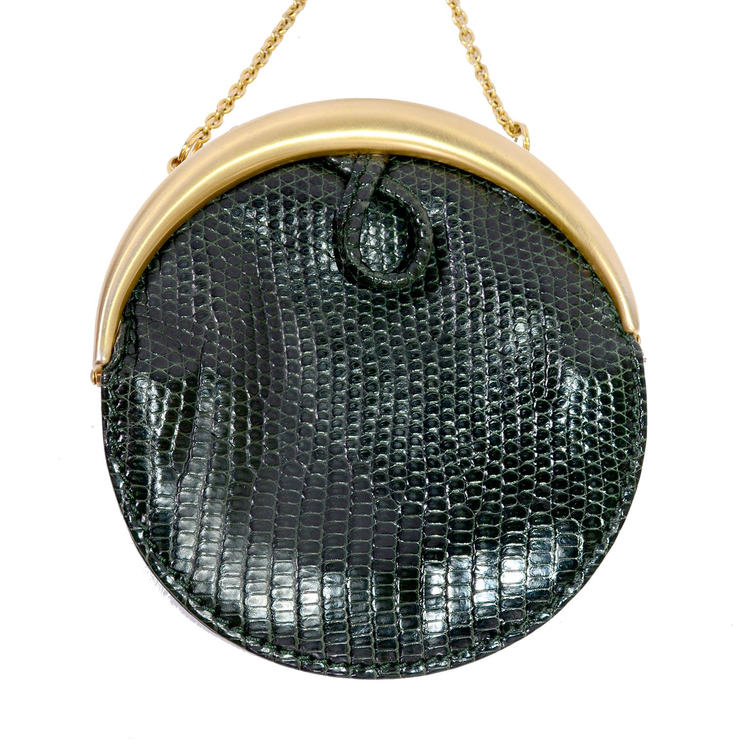This is a great, small round green snakeskin Gucci handbag with gold hardware chain and pronged hook. The green snakeskin is soft and supple and has a loop on both sides. The chain attached to the purse has a gold piece with two prongs that