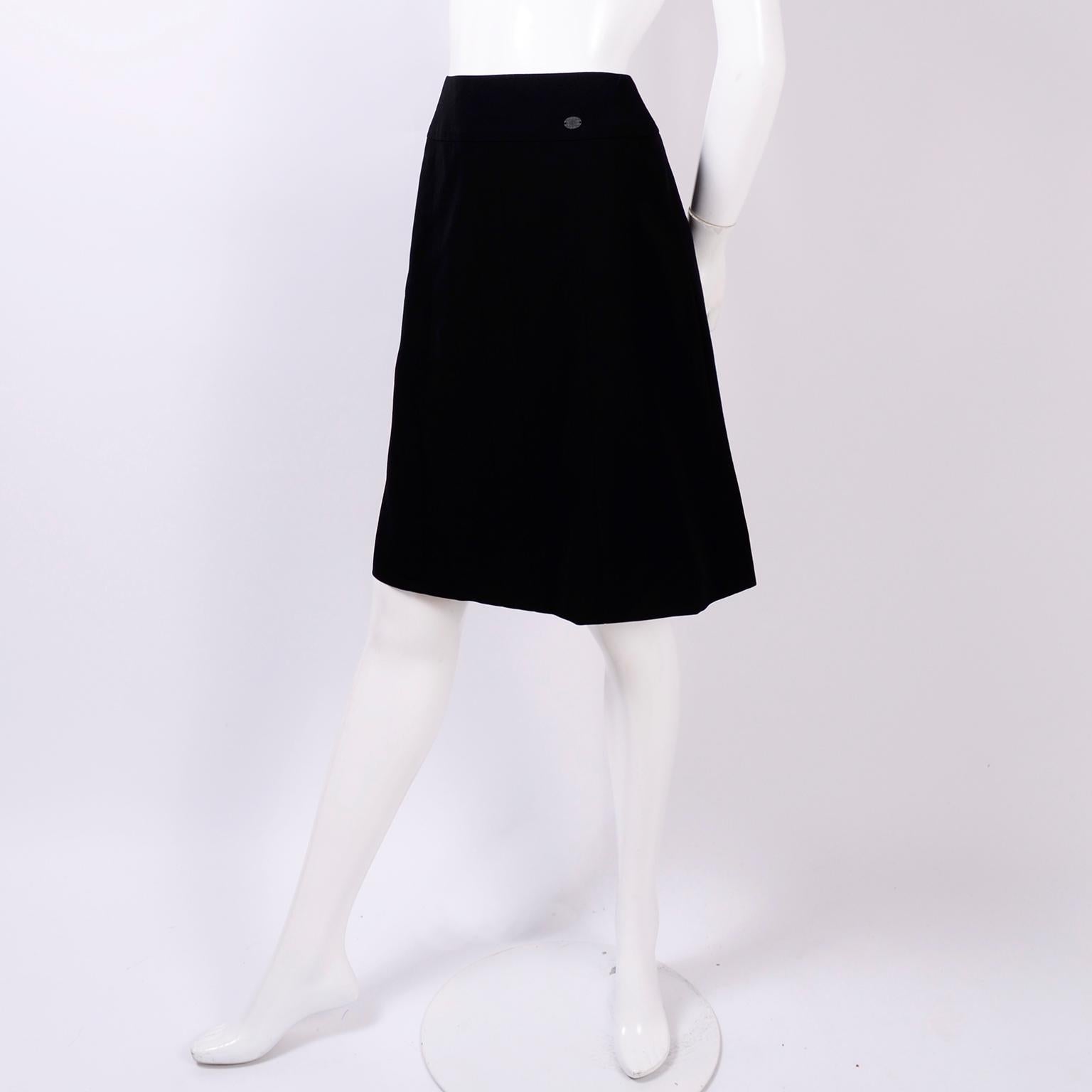 This is a vintage Chanel Spring / Summer 2001 black a-line wool skirt with subtle seams and oval CC logo plate sewn into the waistband. This skirt fits right into the modern aesthetic and can be worn with numerous separates you already have in your