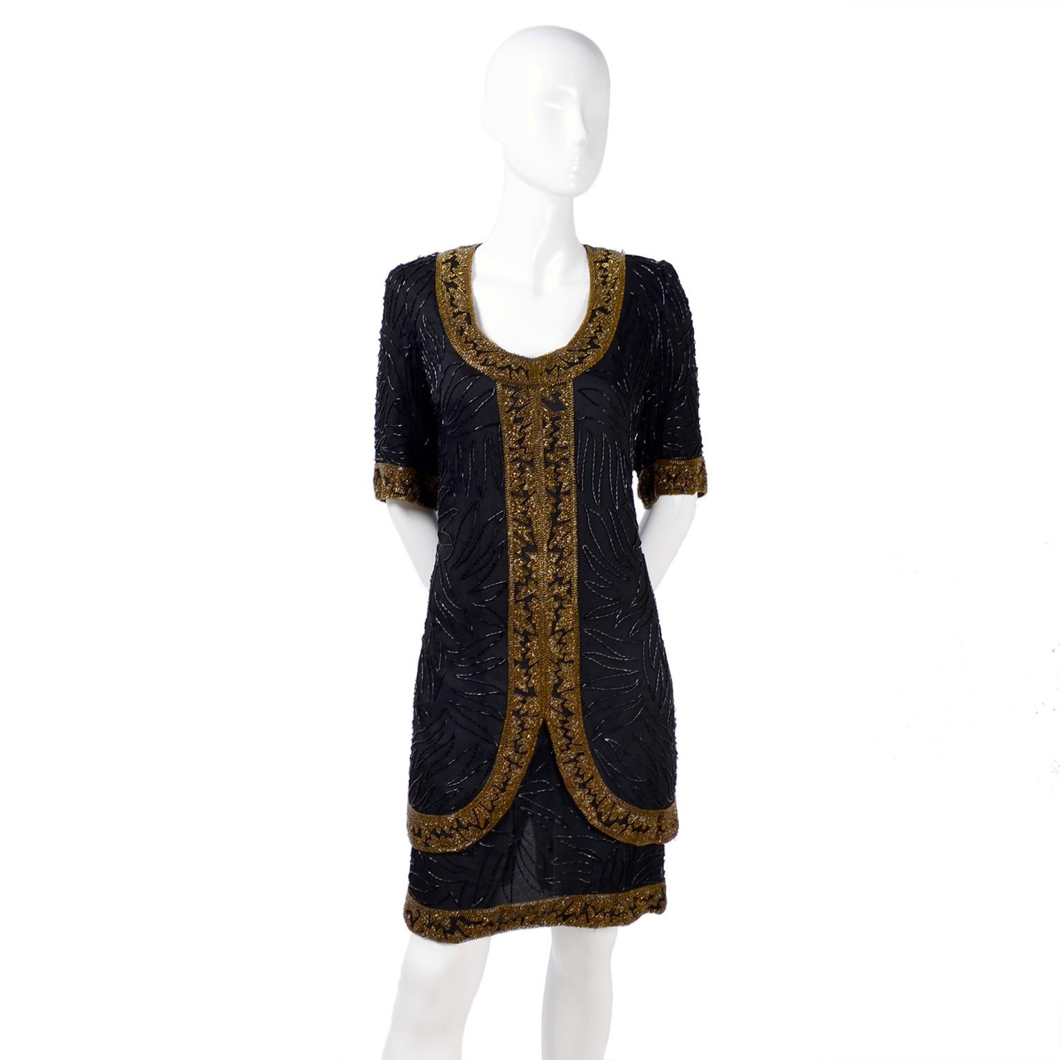 This is a 1980's silk vintage dress with bugle beads of black making leaf-like designs and trim of gold bronze smaller beads. The label reads; Brilliante by J.A. The hem is iered with a layer that looks like a top and skirt, but all one piece. There