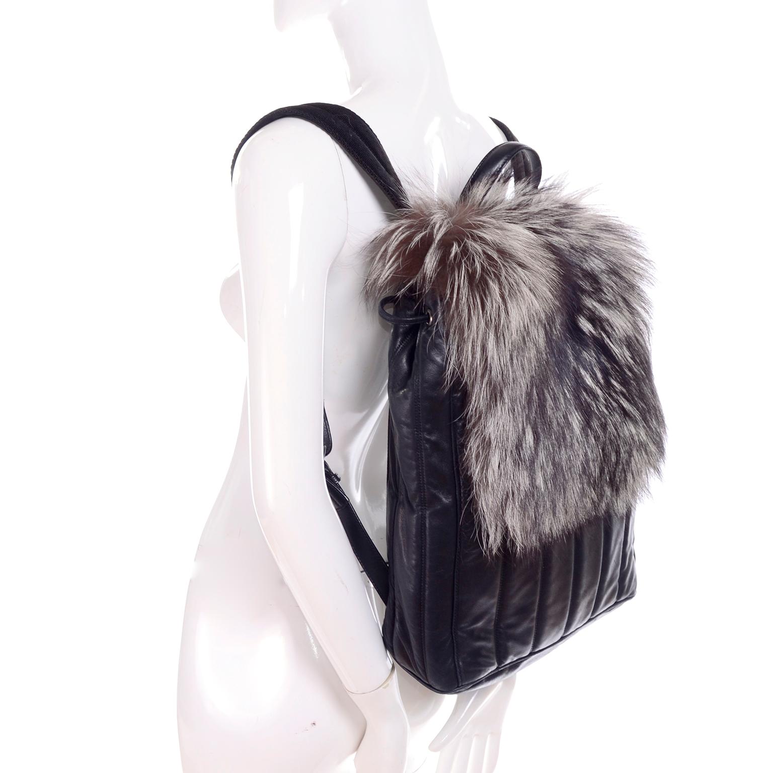 This is an absolutely fabulous Tanner Krolle black leather backpack with gorgeous fox fur.  The bag measures 16 inches high, 12 inches wide and 4 inches deep. This versatile bag  has leather straps, a drawstring at the top, an outside side pocket,