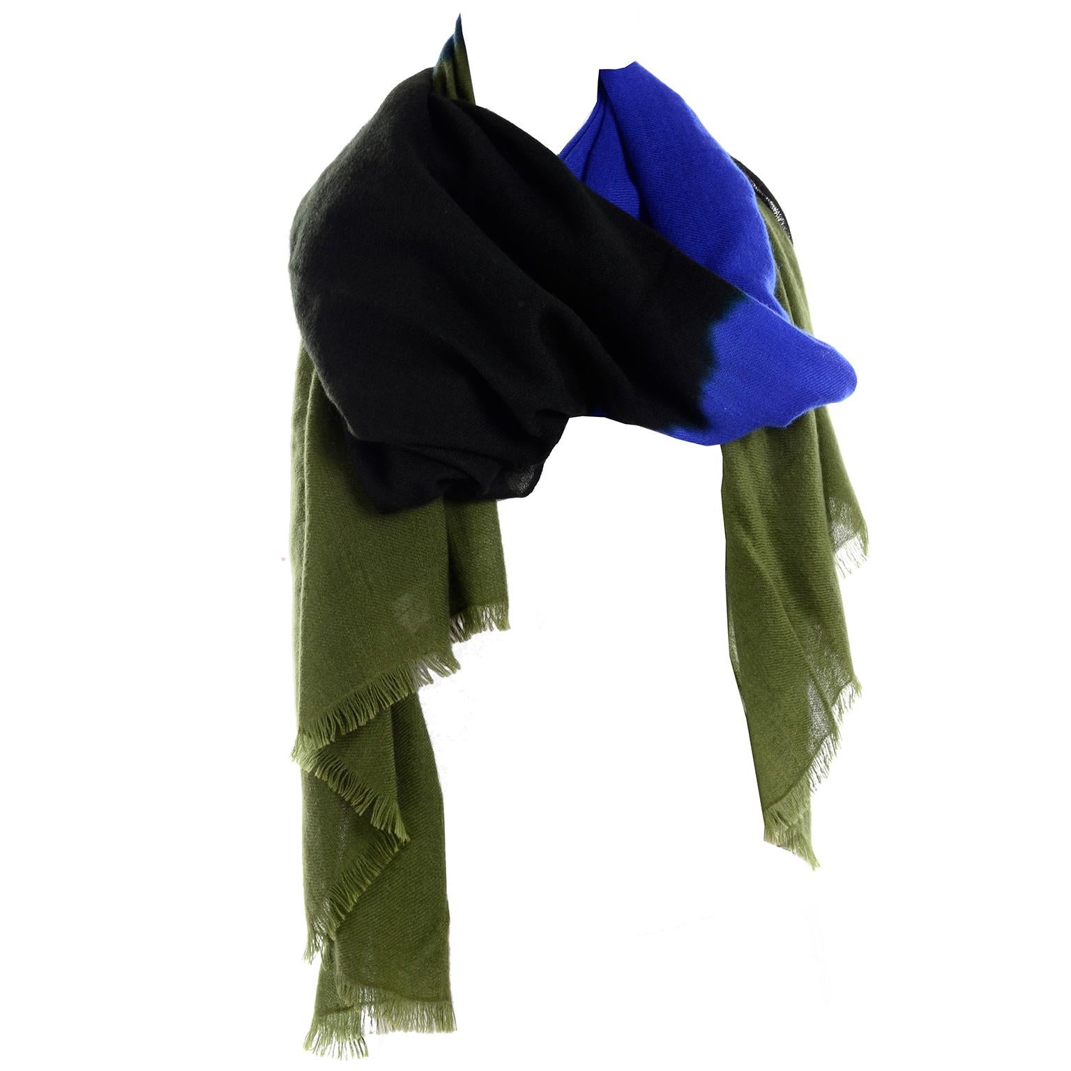 This is such an  incredible 100% cashmere scarf or wrap that was designed by Oscar de la Renta. The scarf was never worn and is in color blocks of Green, black and blue. This lovely piece can be worn as a scarf, wrap or stole and measures 34 X 80