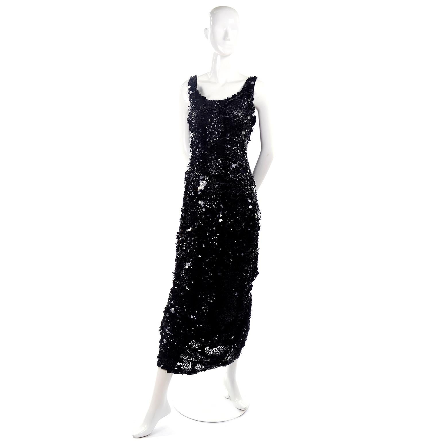 This incredible vintage evening gown is made of a fine mesh net and is entirely covered in shimmering small sequins and large paillettes. The dress is sultry and gives off old Hollywood vibes with a modern twist! The most unique thing about this