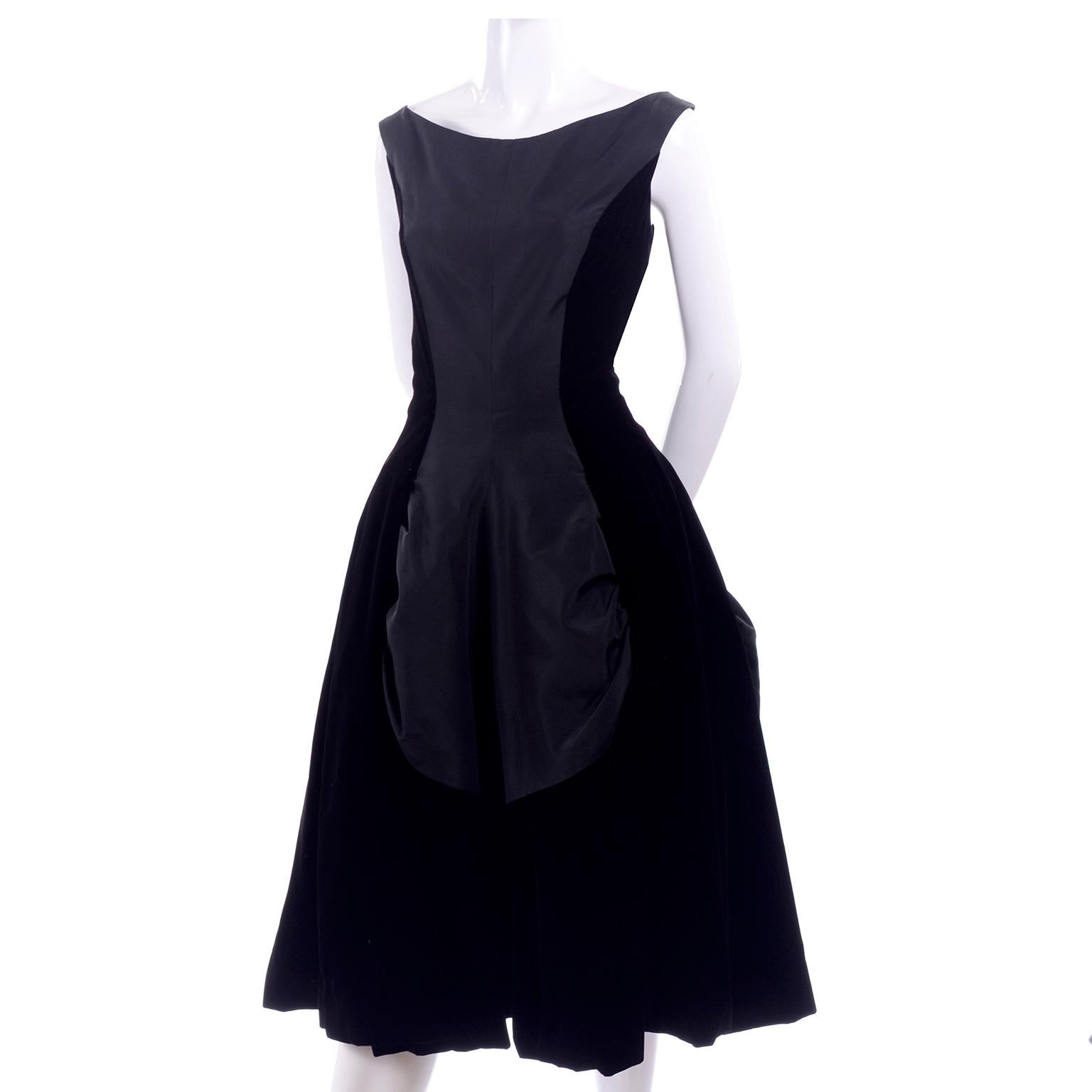 This is a wonderful vintage 1950's dress that is so beautifully made! The dress is black velvet with panels of gathered taffeta and pellon lining. There is a built in full taffeta under skirt and the dress closes with a back metal zipper.  Fits