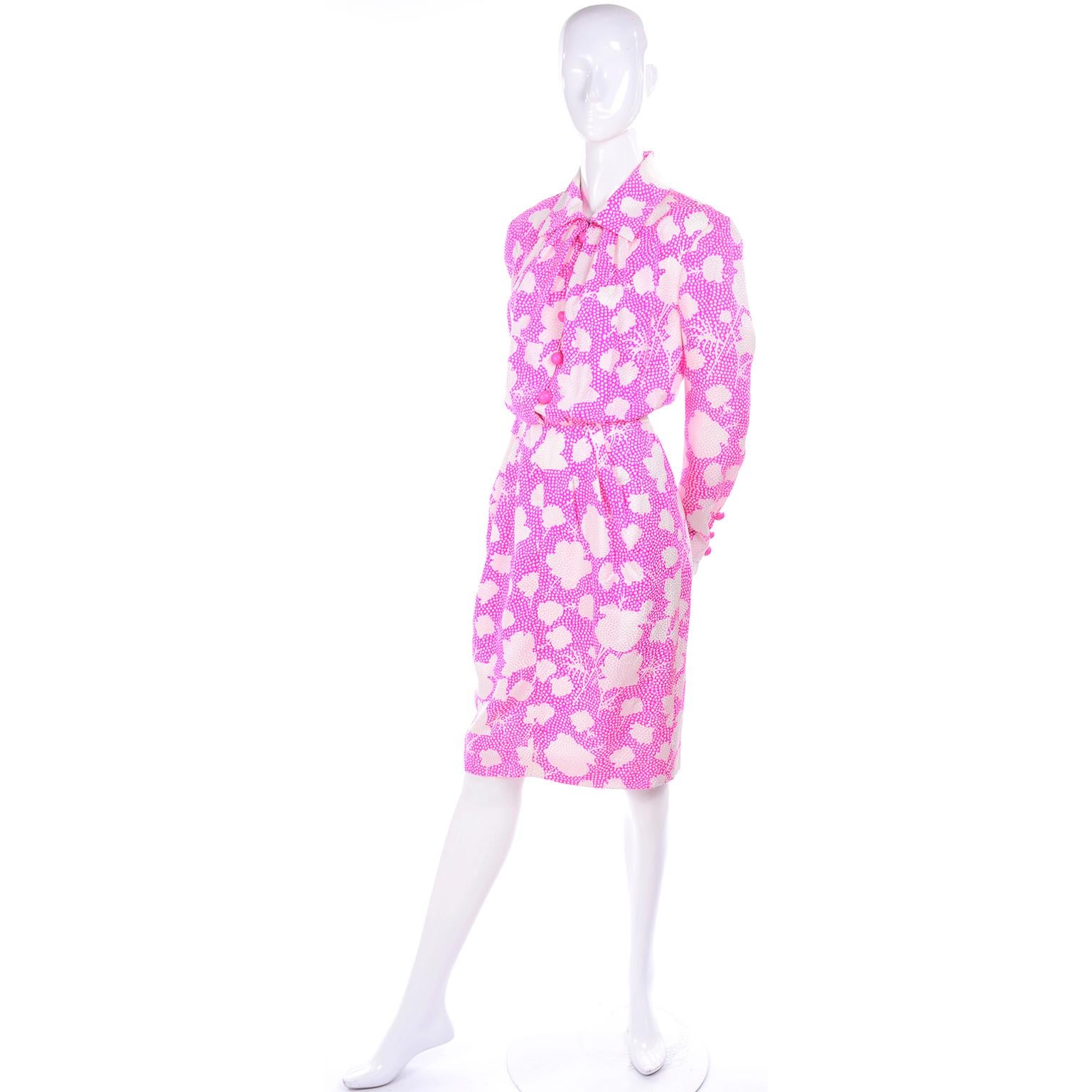 This is a lovely vintage dress from Givenchy with the Givenchy Nouvelle Boutique label from the 1980's. The dress is pink and white floral silk with tone on tone white dots embroidered all over.  The dress closes with front pink dome buttons and a