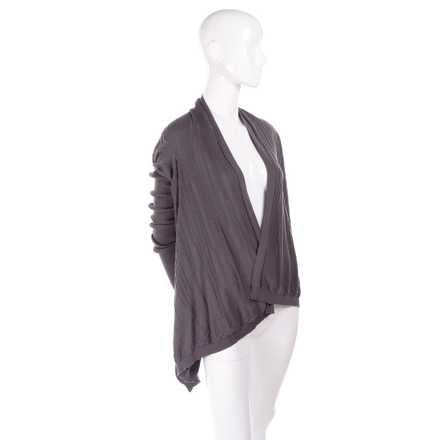 This is a short wrap wool sweater from the 2017 Walrus Collection by Rick Owens.  The sweater has an open front, trapeze hem, and long ribbed sleeves.  This can be worn in a number of ways and is easy to throw on over dresses, with pants, or skirts.