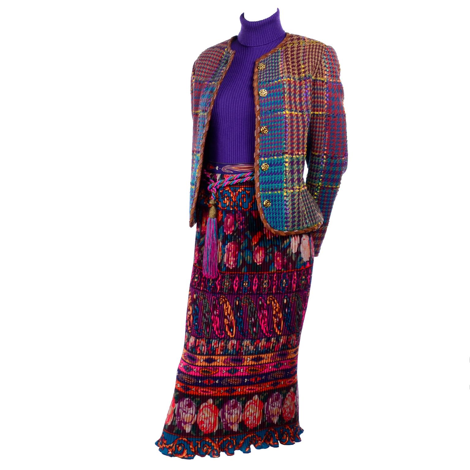 This is a beautiful Emanuel Ungaro outfit with so many wonderful textures, colors and patterns!  This incredible ensemble includes a pleated floral patterned skirt, a purple knit turtleneck, a multi colored tweed jacket, and a colorful rope belt. 