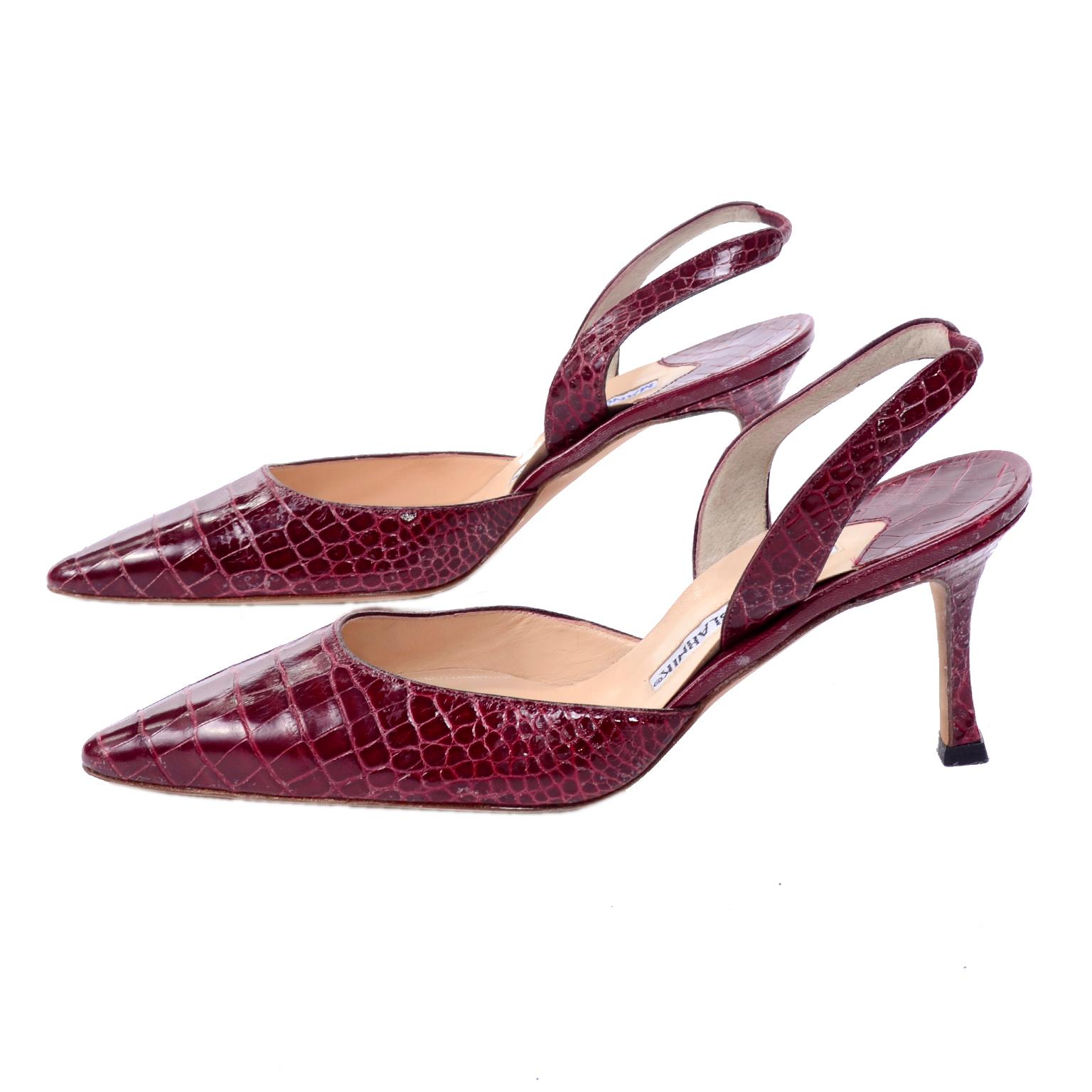 This is a beautiful pair of Manolo Blahnik burgundy crocodile sling backs with a heel and pointed toes.  The shoes appear unworn and are labeled a size 38.5. Manolo Blahnik shoes tend to run a half size small, so if you normally wear a size 38 in