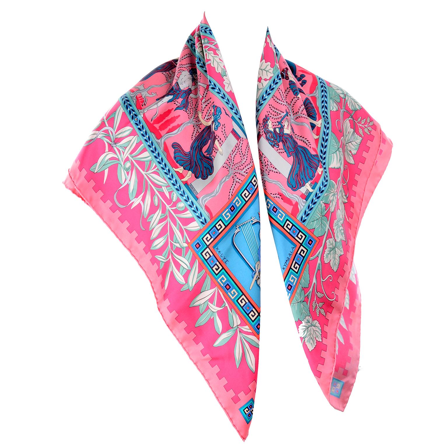 This is a beautiful Hermes Musique Des Dieux Silk Scarf designed by Claudia Stuhlhofer Mayr in 1996. Depicting mythological creatures and musical instruments, this pink, green and blue scarf is so lovely! The scarf is approximately 35