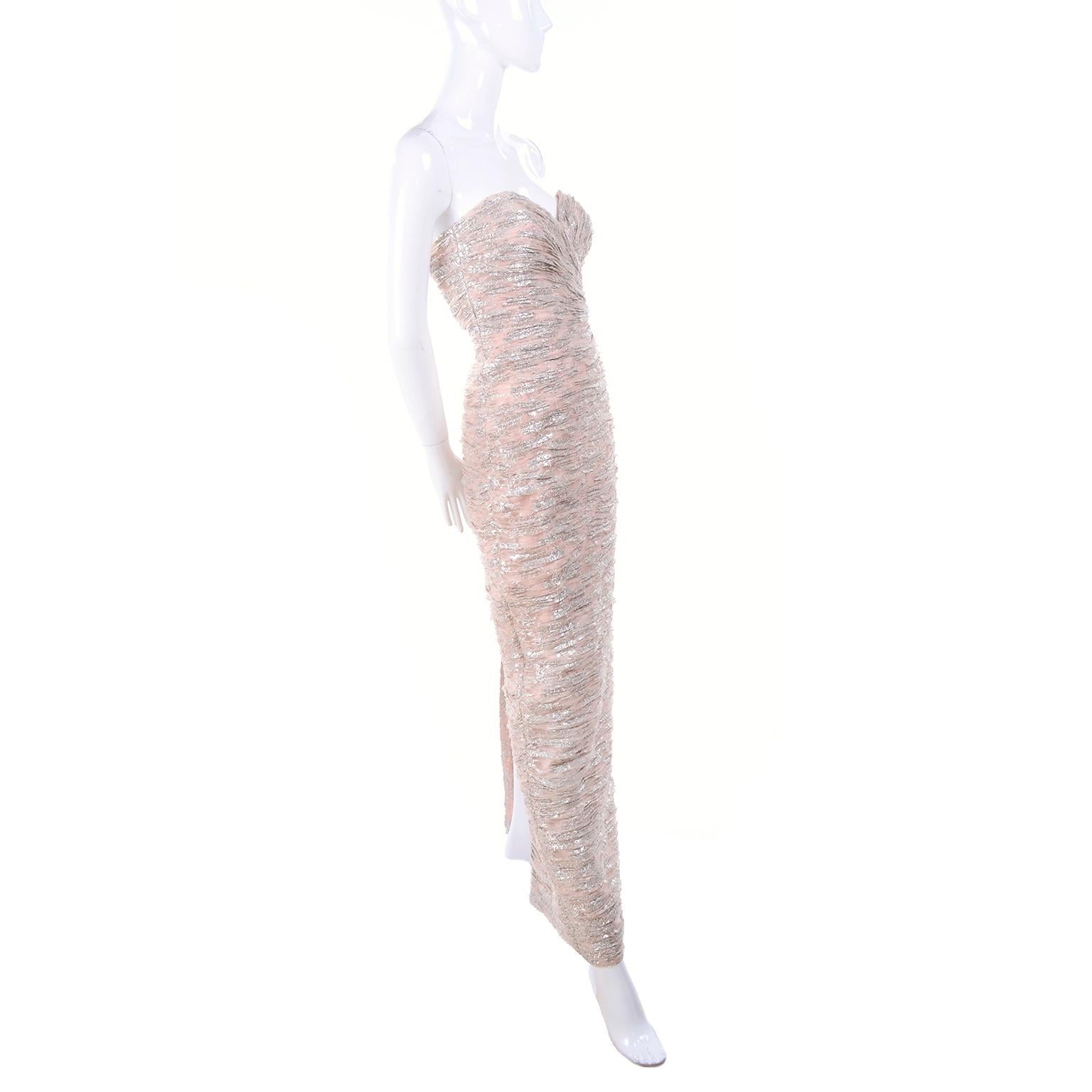 This Vicky Tiel strapless, ruchéd pale buff pink and silver metallic evening gown has a sweetheart neckline and is new with its original price tag for over $900. There is a back hidden zipper and hook and eye for closure and the dress is fully