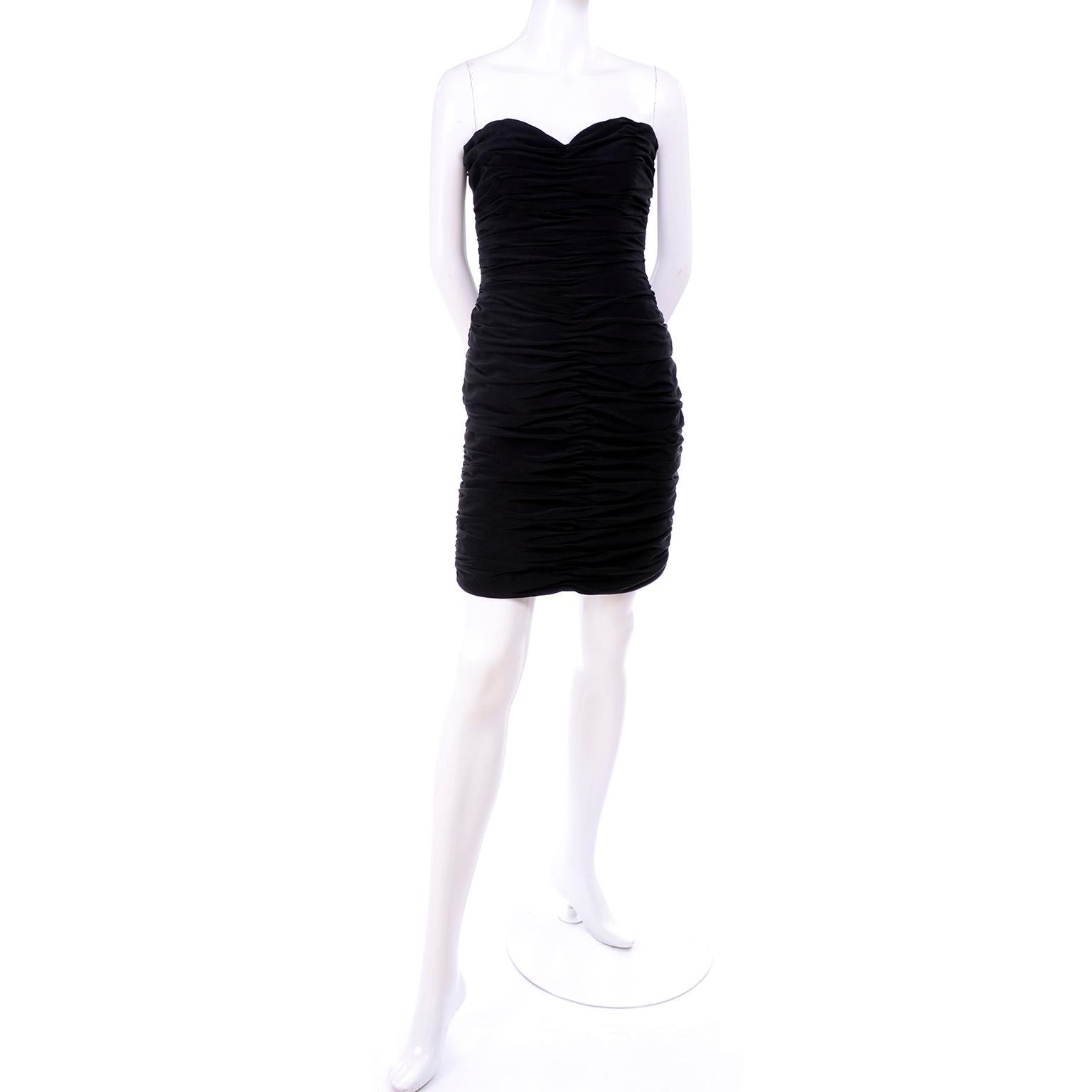 This is a gorgeous 1980's Azzaro Boutique bodycon vintage dress in ruched fine black crepe. The strapless little black dress has a back zipper and boning in the bodice. Fits our size 2 mannequin perfectly! The dress has a label that reads: Betsy and