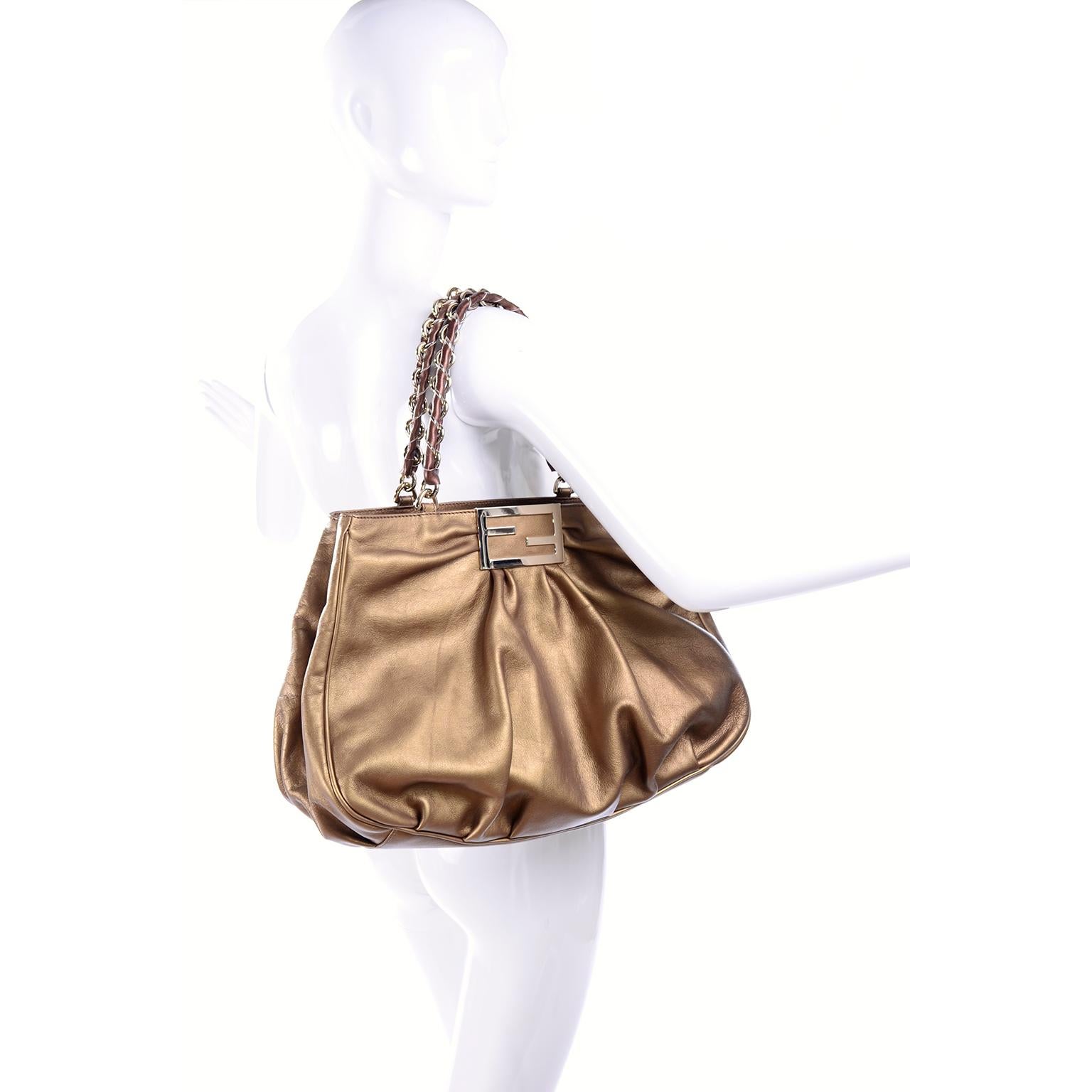 This is a gorgeous Fendi bronze leather Borsa Mia shoulder bag that appears unused and it still has its original card inside.  The handbag measures 12