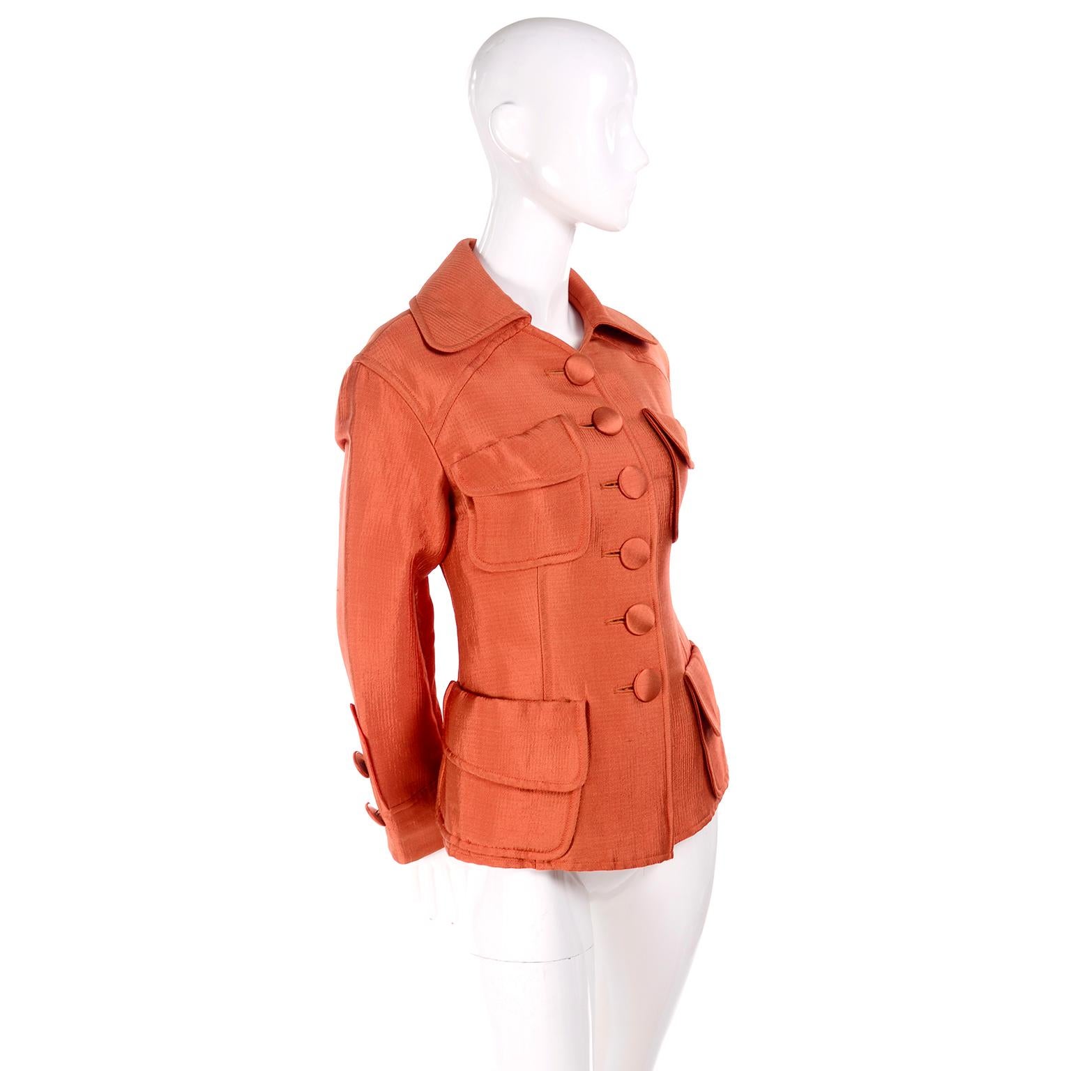 This is a fabulous vintage rich orange jacket from Christian Lacroix. The jacket has 4 front pockets and buttons up the front. This fitted jacket is labeled a size 40 and we estimate it to fit a modern day size 4 or Small. The color is a rich