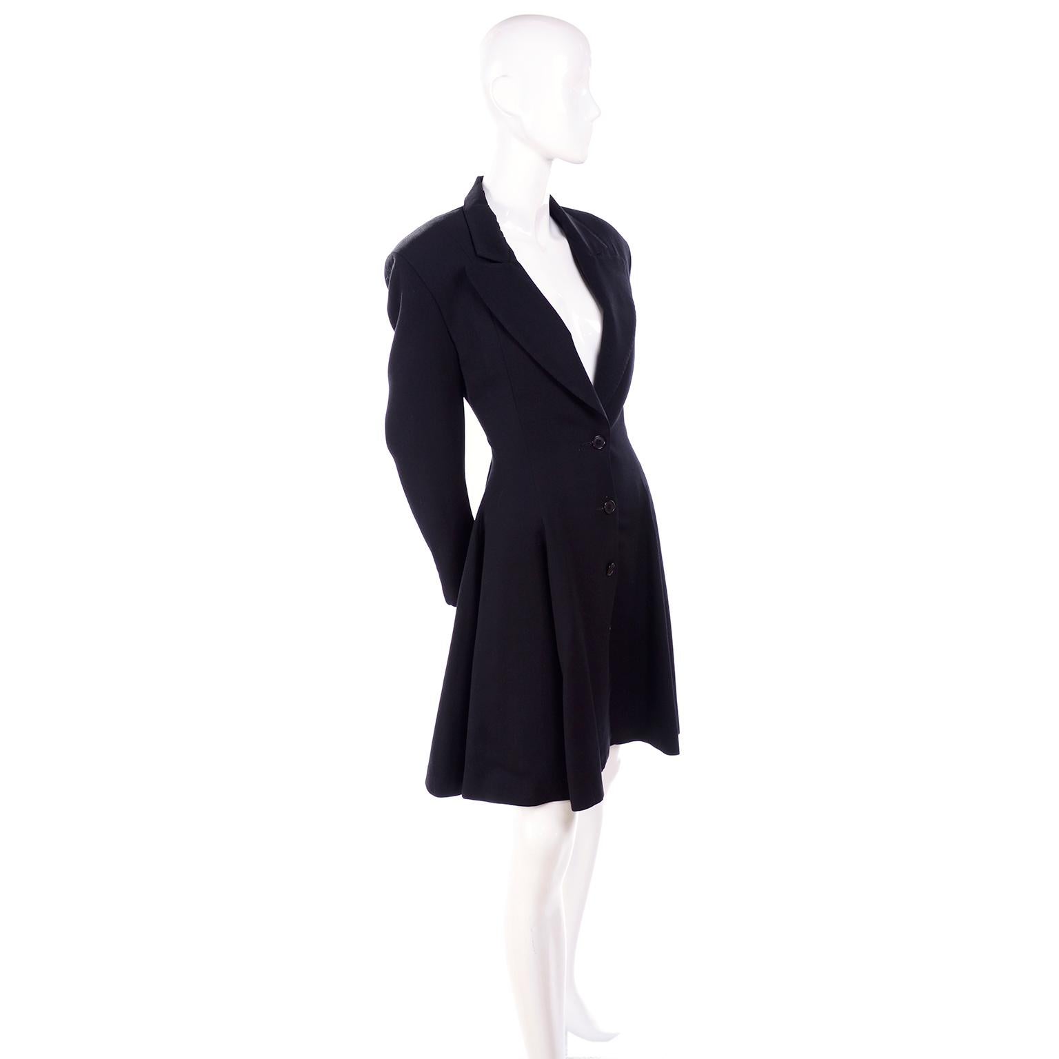 This is a wonderful vintage jacket from the 1980's designed by Norma Kamali. This black wool blazer is tapered at the waist and full from the waist down. Fully lined with side slit pockets, the jacket fits a size 4. There are built in shoulder pads