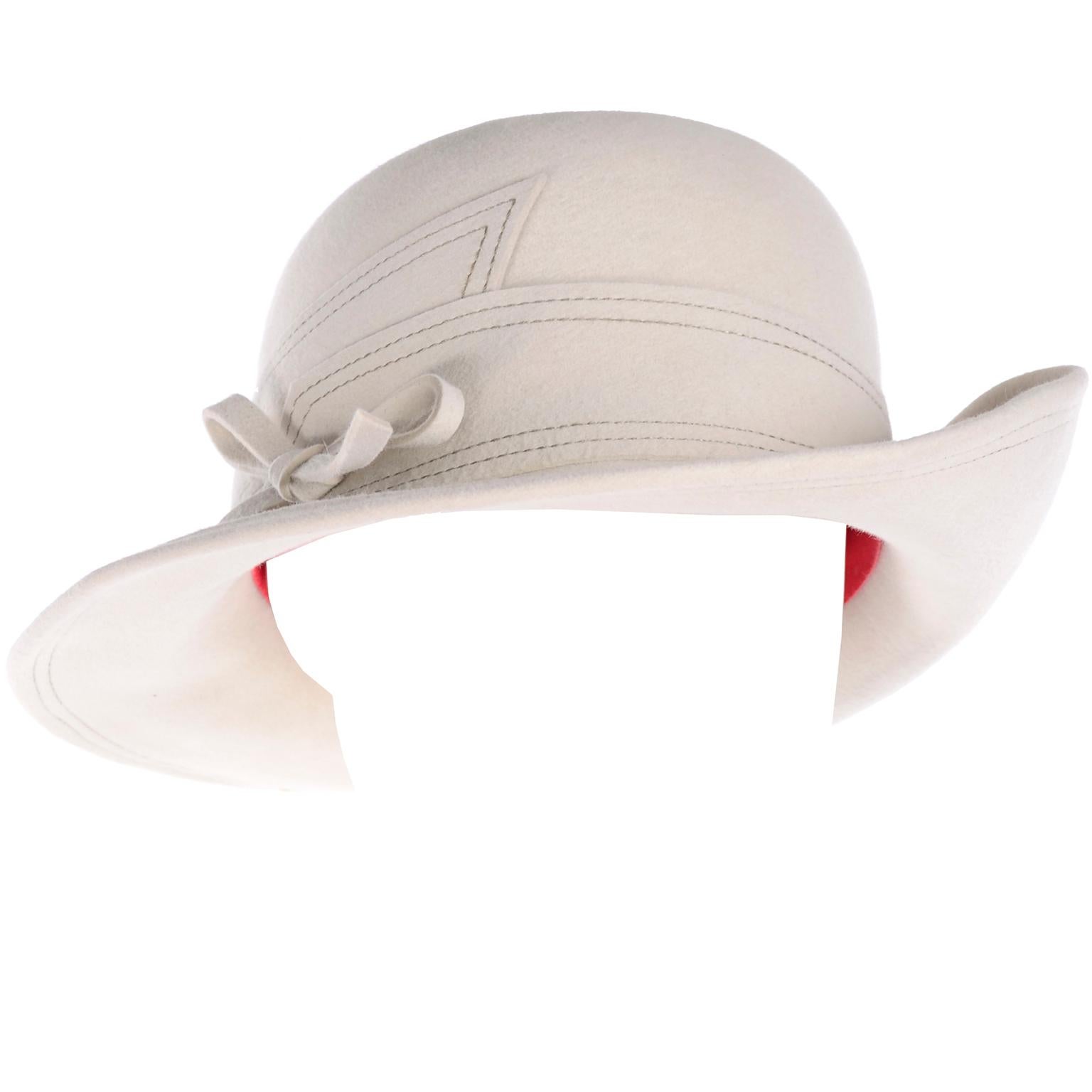 This beautiful vintage cream wool hat from Adolfo was purchased at Marshall Field in the 1970's.  The hat has incredible contrasting brown topstitching and a pretty bow. One side has an upturned brim that is secured with a thread. The hat measures