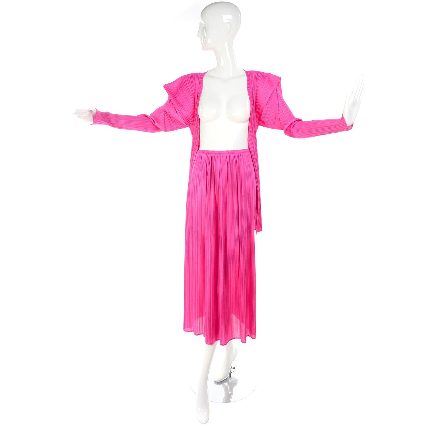 This is a great hot pink pleated Issey Miyake Skirt and top or Cardigan ensemble. This outfit came from an estate we acquired of exceptional avant garde designer clothing and accessories.  The open front cardigan top has asymmetrical structured